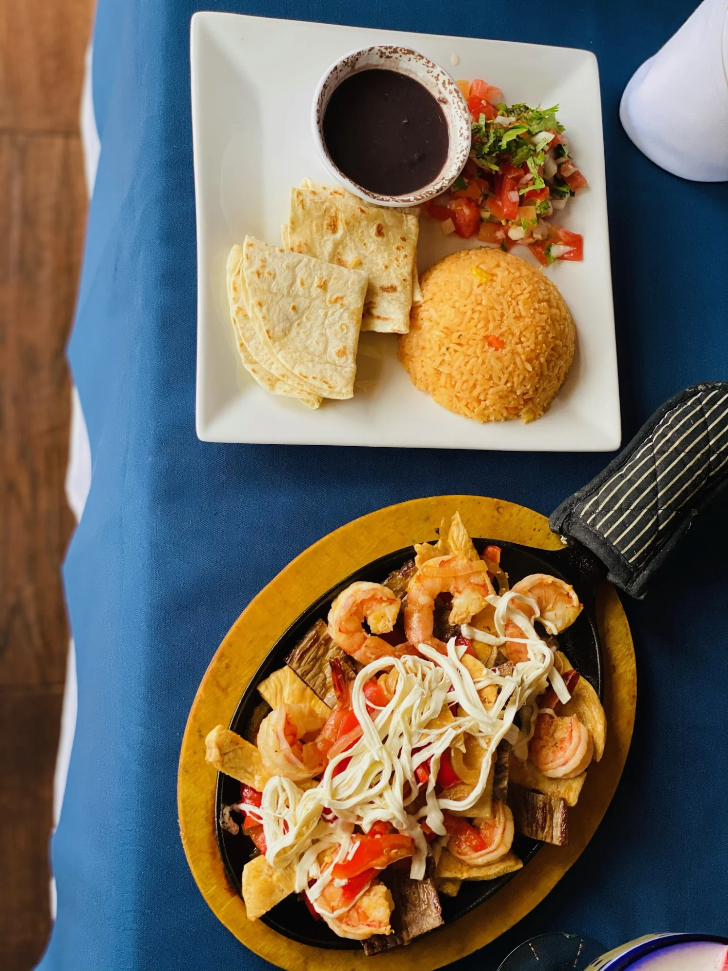 Plate of shrimp fajitas and rice with sides at La Iguana Azul, Great Kills.