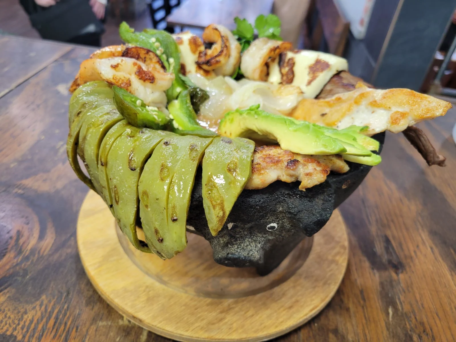 San Jose Restaurant featured image A dish featuring grilled meat, avocado, and cactus on a wooden platter at San Jose Restaurant, Mott Haven.