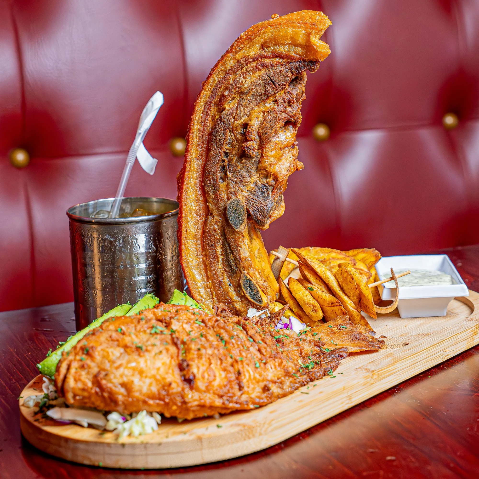 Nuevo Three Way Restaurant featured image Fried fish with crispy pork skin and plantains on wooden board at Nuevo Three Way Restaurant, Belmont.