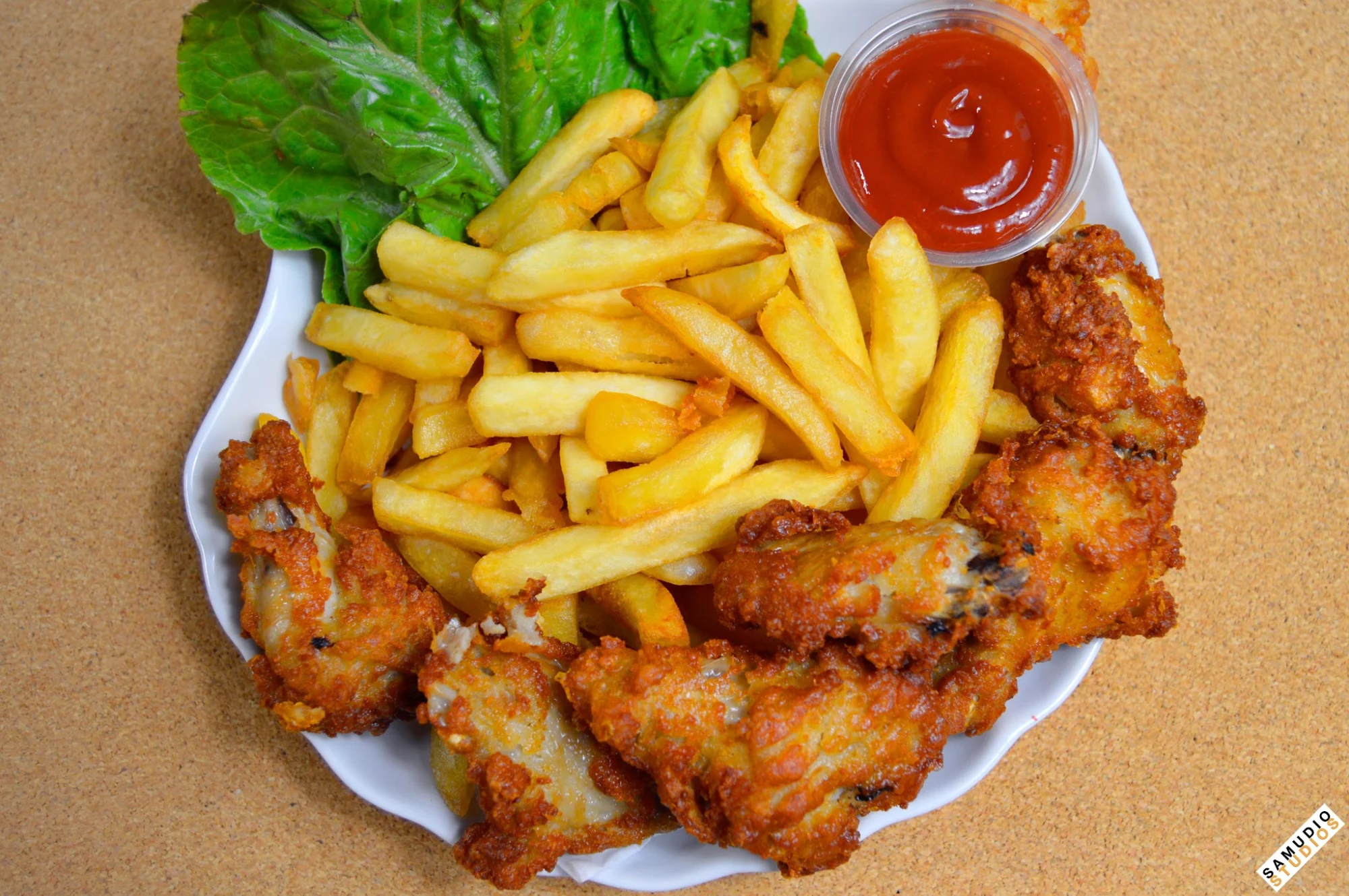 Boston Gourmet Deli featured image Plate with fried chicken wings, French fries, lettuce, and ketchup at Boston Gourmet Deli, Edenwald.