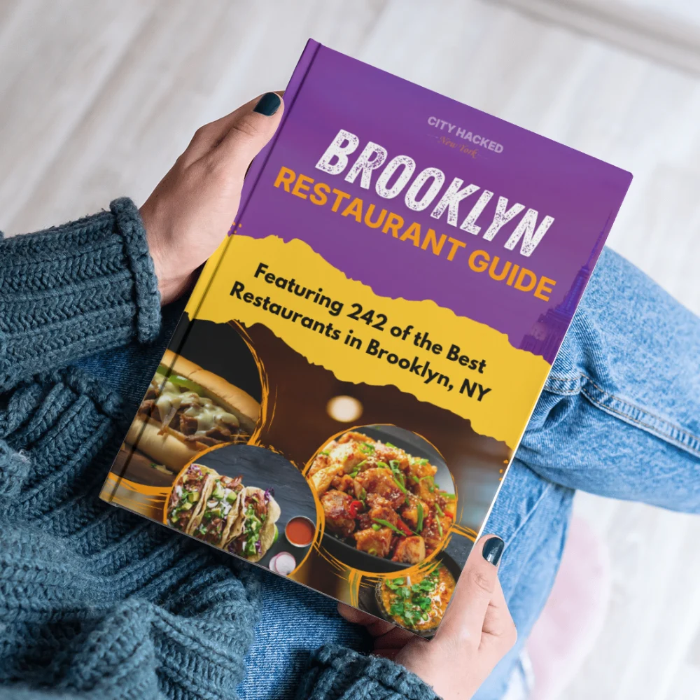 Brooklyn Restaurants Guide showcasing the best places to eat in Bronx, NY being held in someone's hands