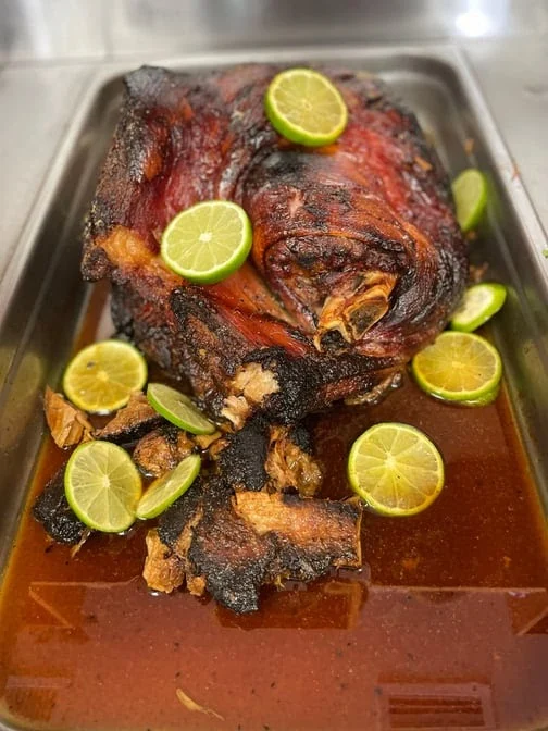 Roasted meat with lime slices at El Punto de la Chama Restaurant & Bar, Soundview.