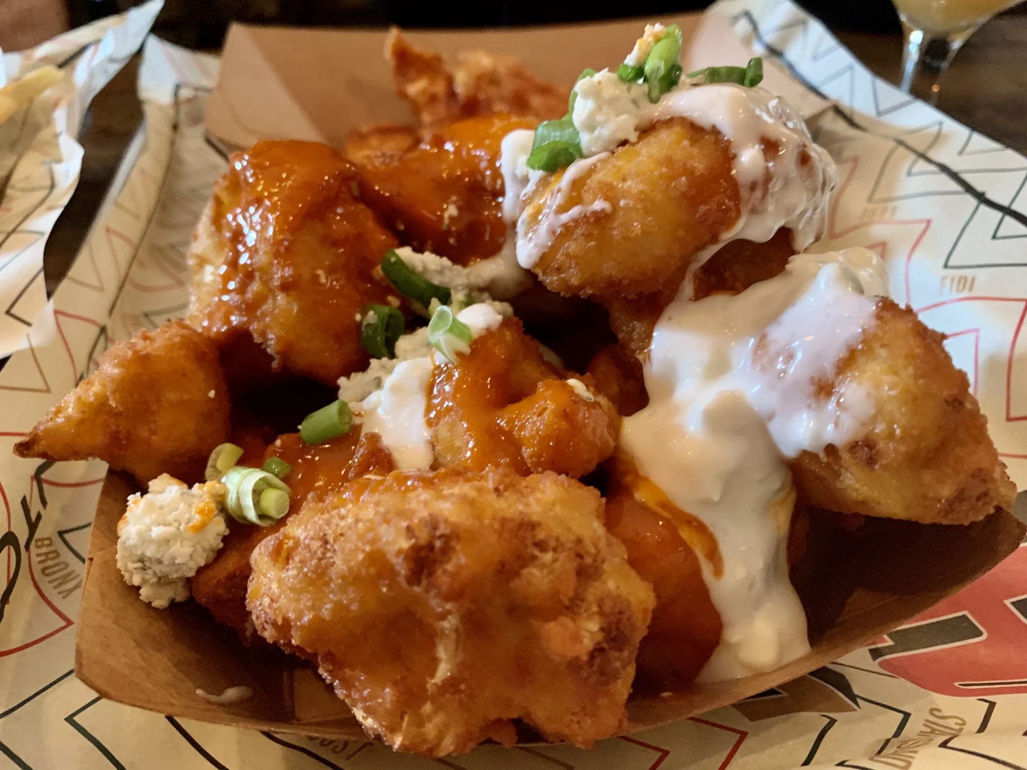 Clinton Hall featured image Plate of chicken wings with sauce and scallions at Clinton Hall, Belmont.