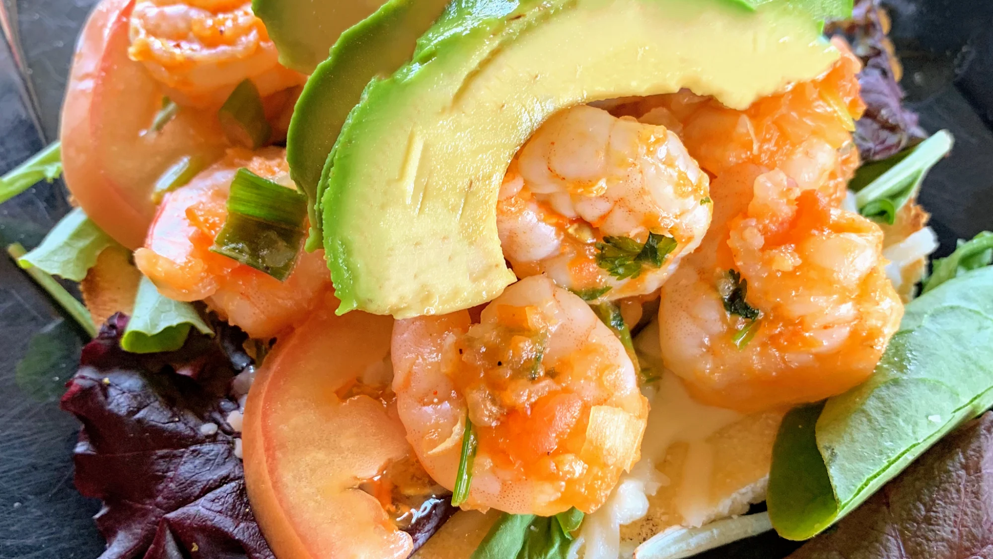 Shrimp dish with avocado slices and greens at La Masa Restaurant, Parkchester.