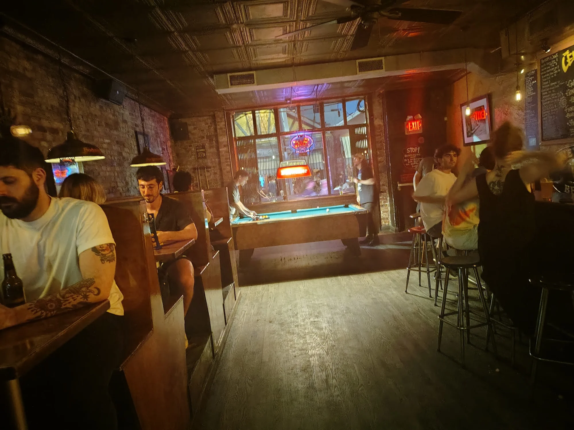 The Levee interior with pool table and patrons in Williamsburg, Bronx NYC.