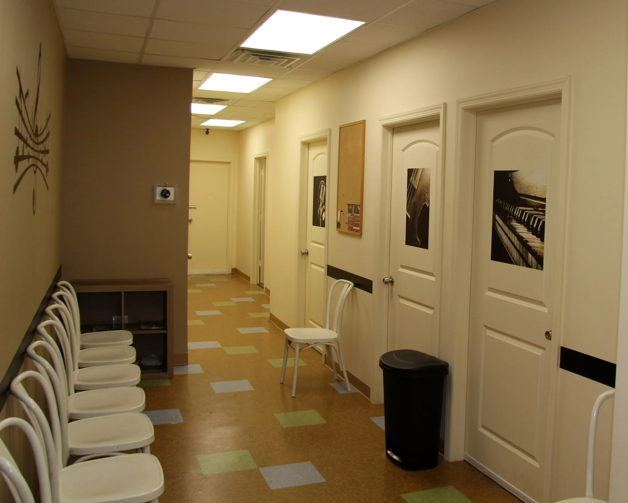 Interior hallway with chairs and decorated doors at Victory Music Studio in West New Brighton, Bronx NYC.