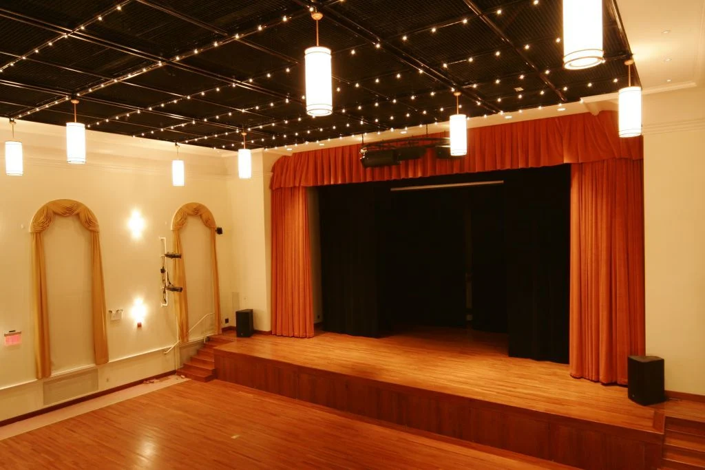 Stage with red curtains and lighting at Jamaica Center for Arts and Learning, Jamaica, Bronx NYC.