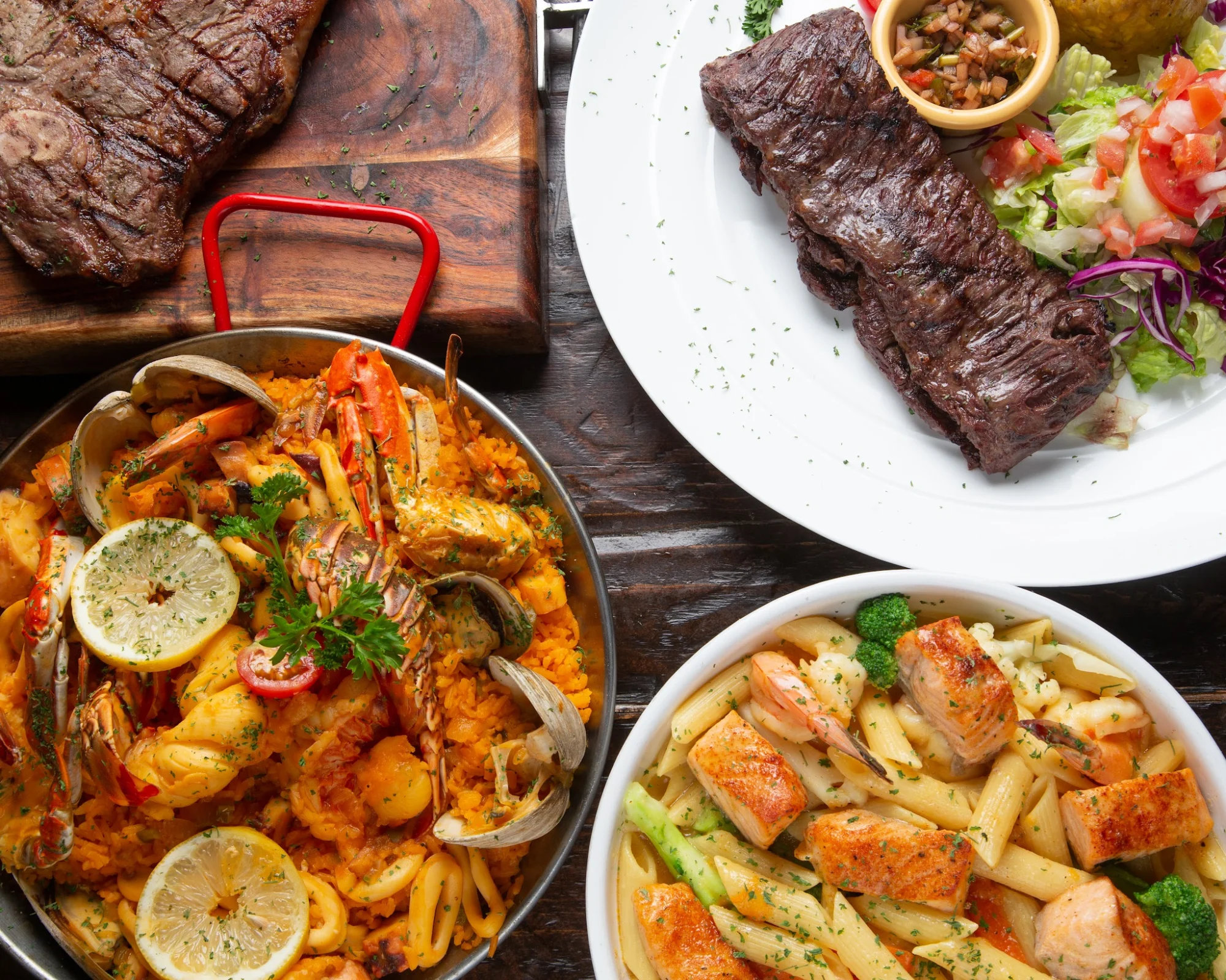 Cafe Colonial Restaurant featured image Assorted dishes including seafood paella, steak, and pasta at Cafe Colonial Restaurant, Van Nest Bronx.