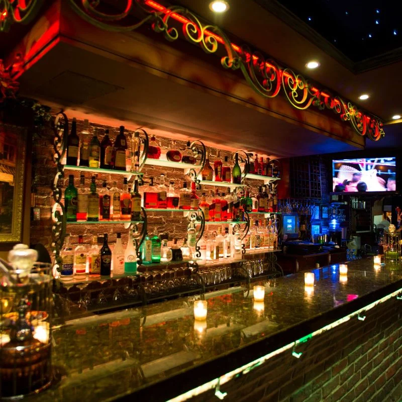 Deja Vu New York interior bar with illuminated shelves and colorful lighting, Astoria, Bronx NYC.