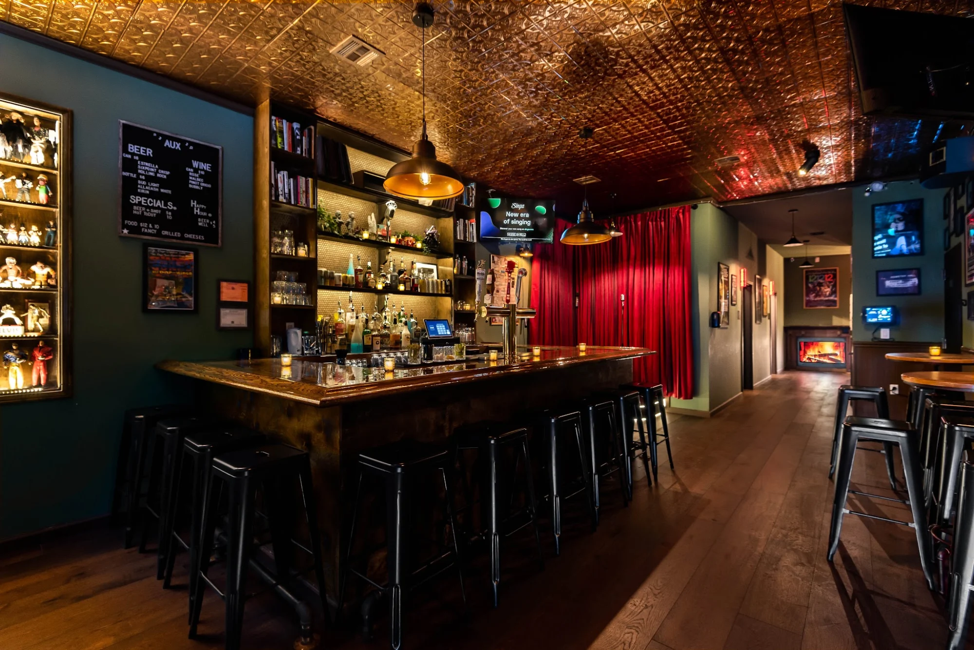 AUX Karaoke Box featured image Interior of AUX Karaoke Box in Bedford-Stuyvesant, showing a bar with stools and warm lighting.