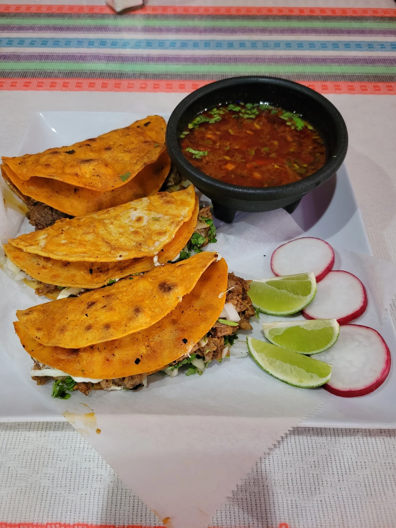 Three tacos with meat, cilantro, and a side of lime and radish at Cinderella's Mexican Restaurant, St. George.