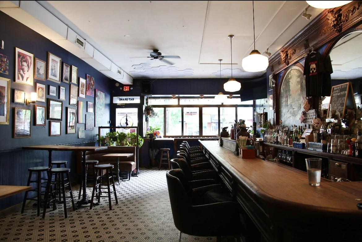 Crystal Lake Brooklyn featured image Interior of Crystal Lake Brooklyn in Williamsburg with bar, stools, and decorated walls.