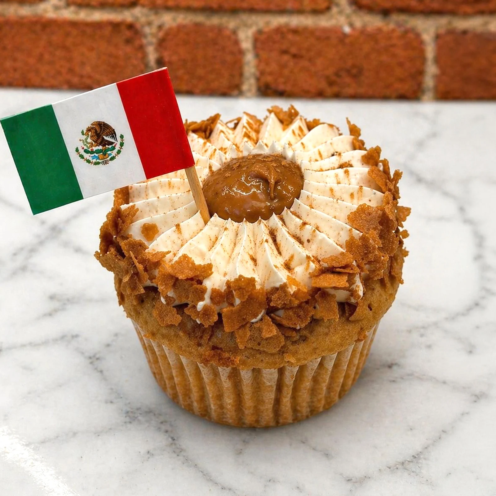 Cupcake with Mexican flag toothpick on marble surface, Huascar & Co. Bakeshop, Hell's Kitchen.
