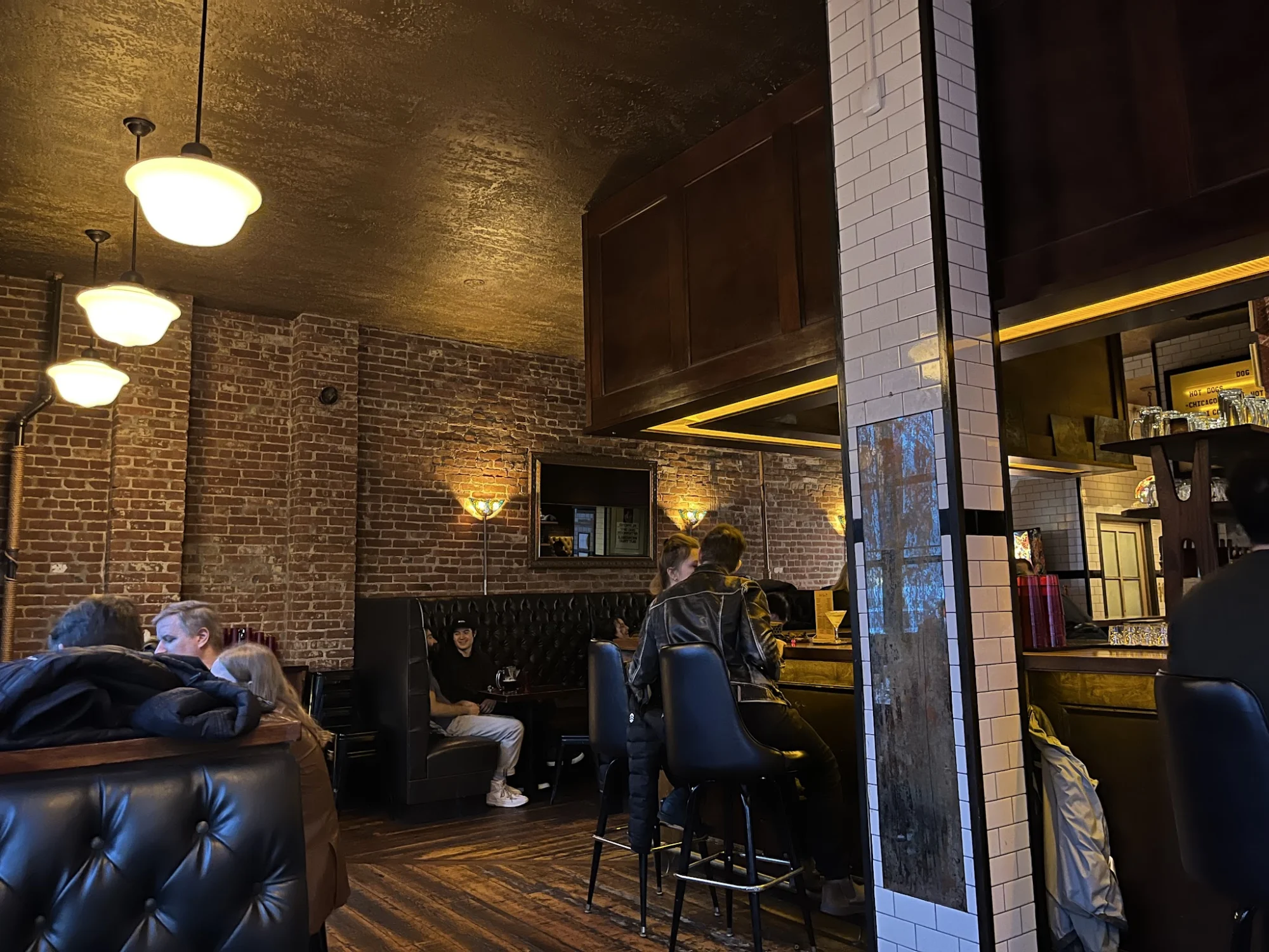 H&H Reserve featured image Interior of H&H Reserve, Williamsburg, Bronx NYC, showing a cozy seating area with exposed brick walls and dim lighting.