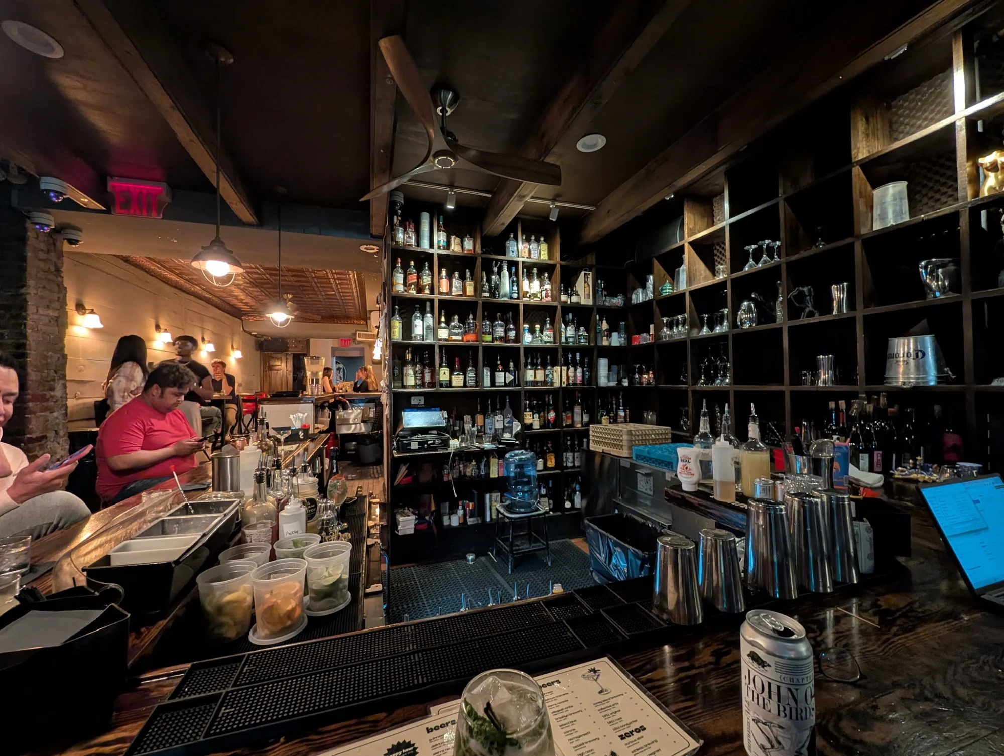 Ten Degrees interior bar scene, well-stocked shelves and patrons at the bar in East Village.