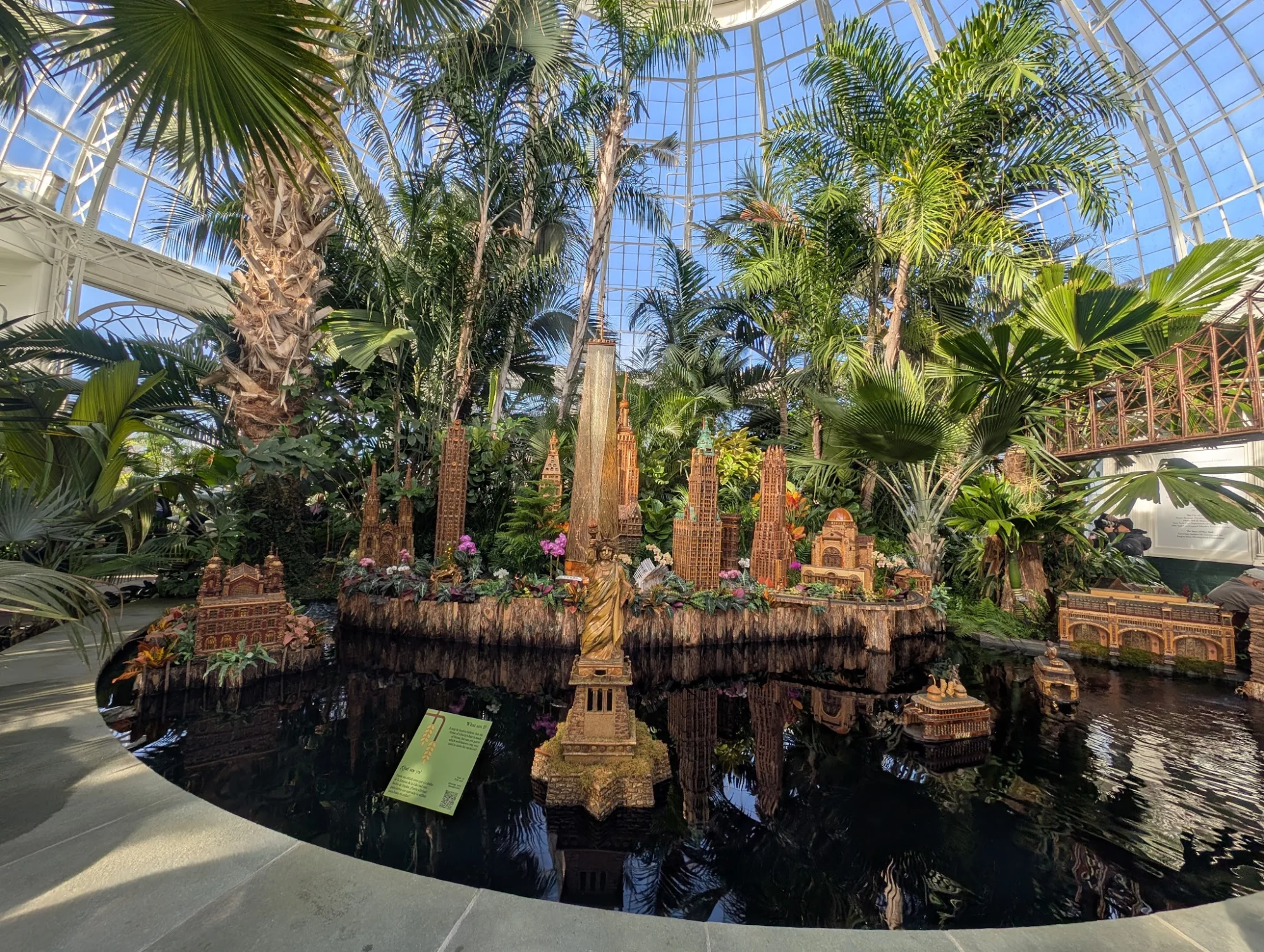 Enid A. Haupt Conservatory, NYBG featured image Large indoor display with tall tropical plants and miniature landmarks in Enid A. Haupt Conservatory, Bronx.