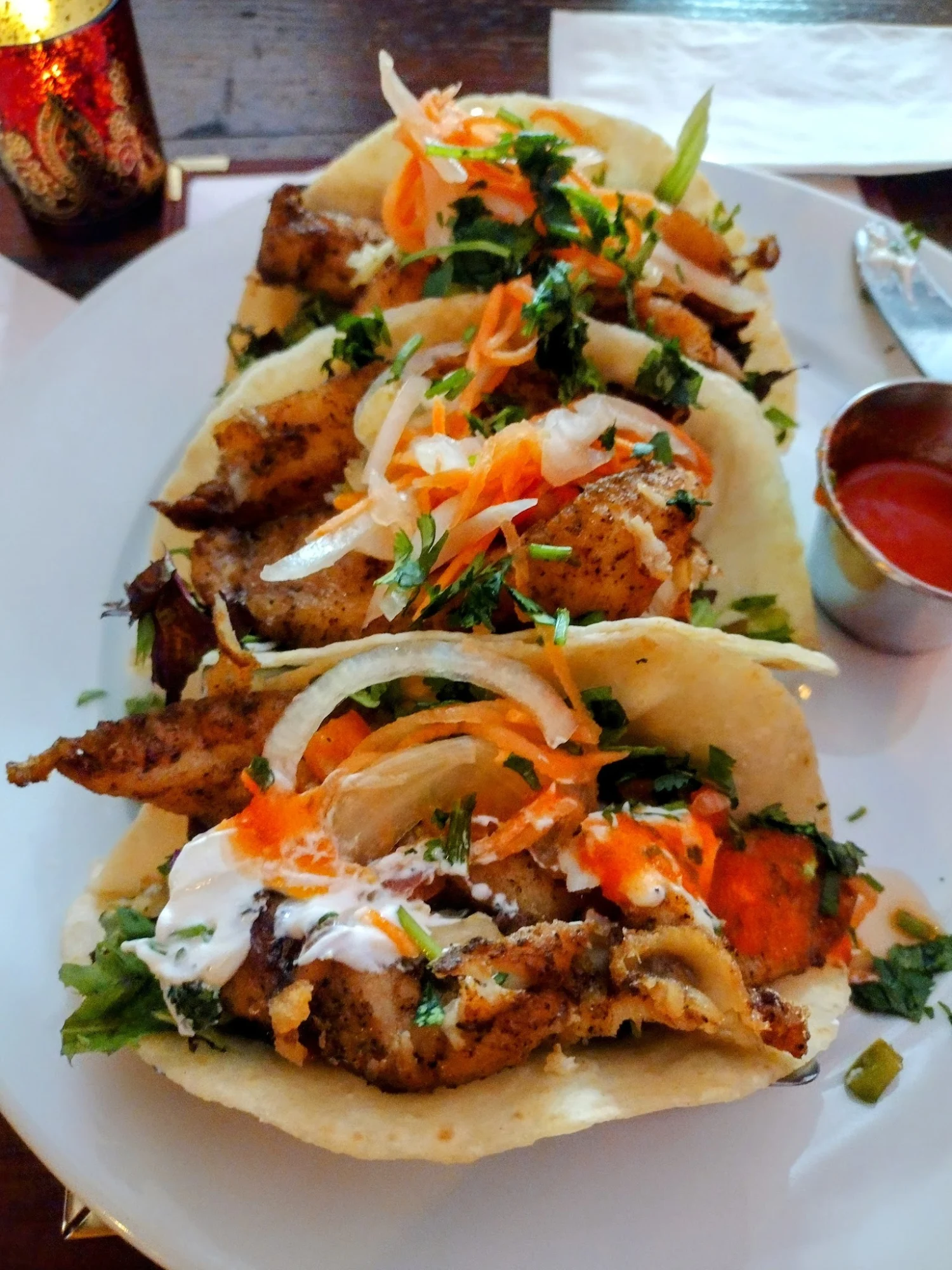 Ripe Kitchen & Bar featured image Plate of tacos with chicken, onions, and herbs at Ripe Kitchen & Bar.