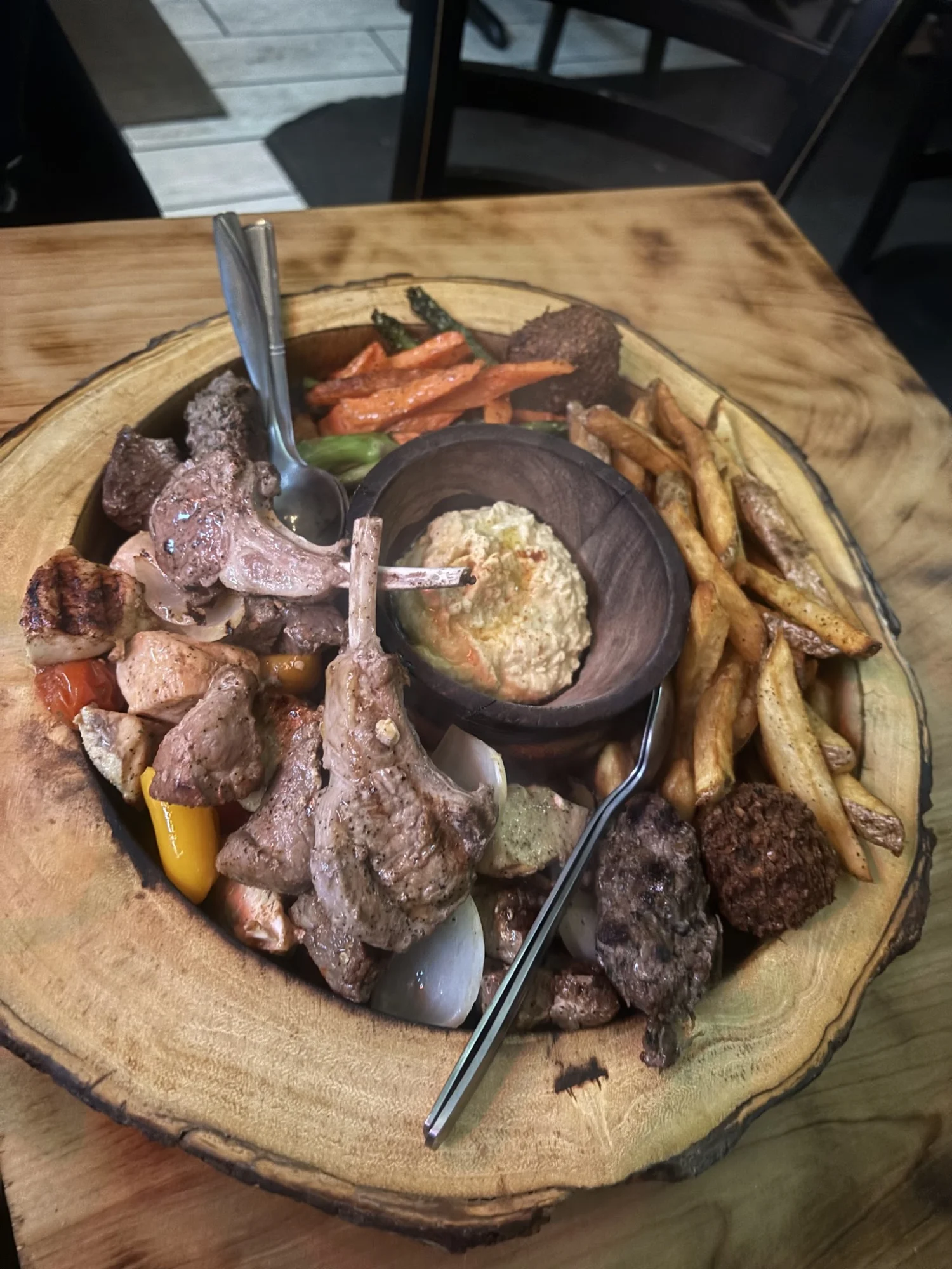 Mixed grill platter with lamb chops, grilled vegetables, and hummus at El Toum, Jackson Heights.