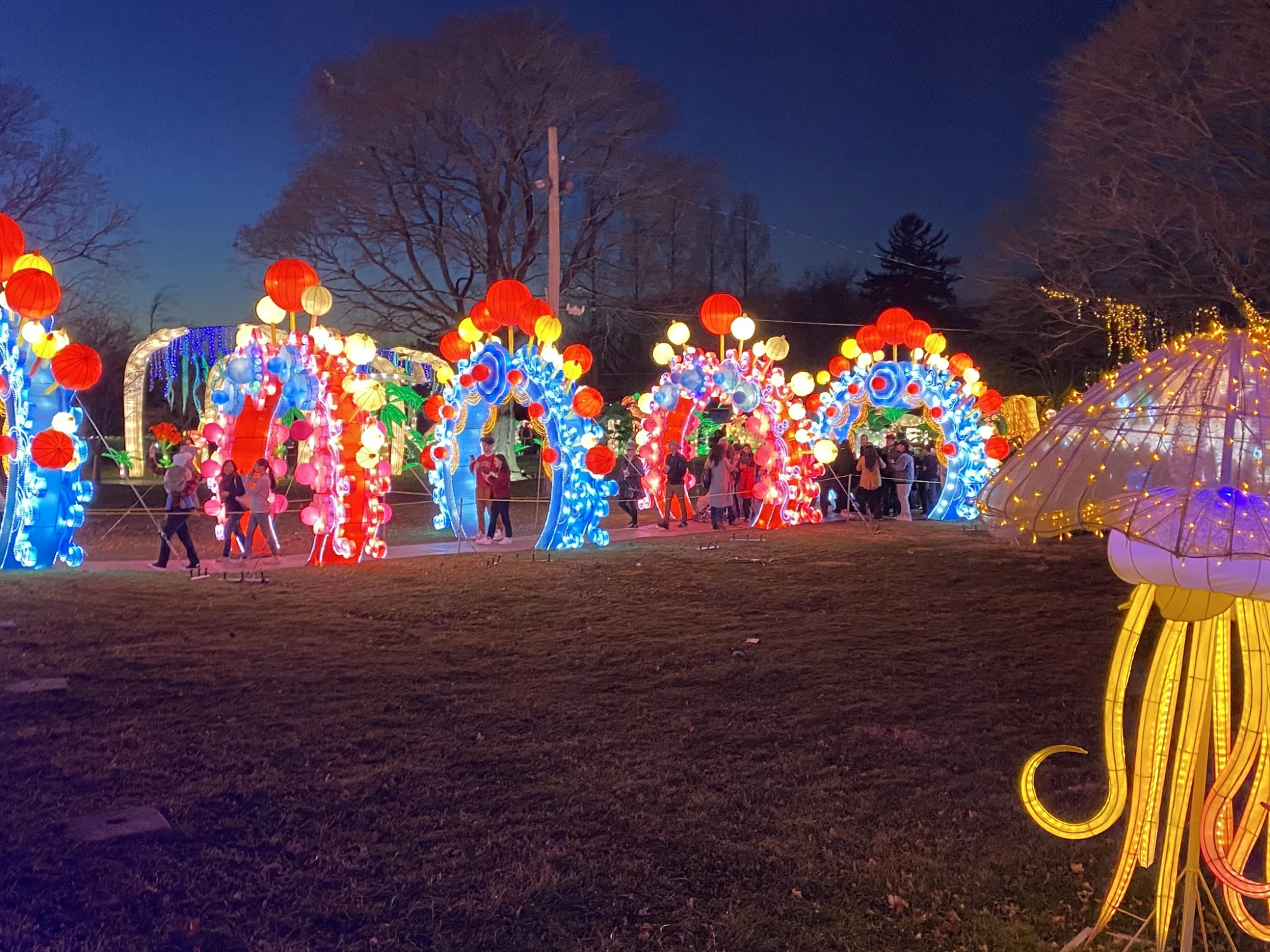 Colorful illuminated arches and decorations at night in Staten Island Museum at Snug Harbor, St. George.
