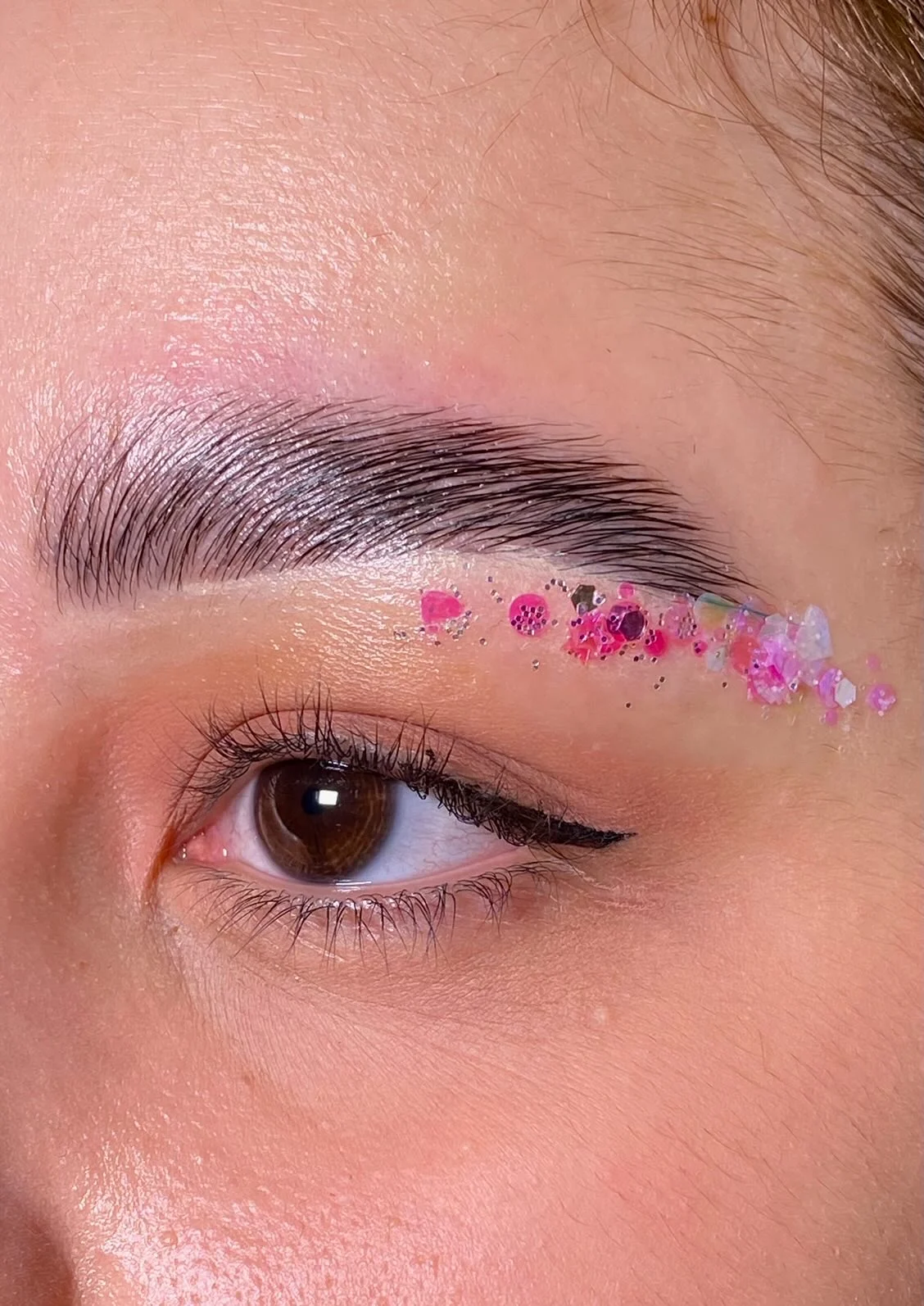 Lash Espresso | Keratin Lash Lift NYC | Brow Lift featured image Close-up of a styled eyebrow with decorative pink accents at Lash Espresso, NoMad.