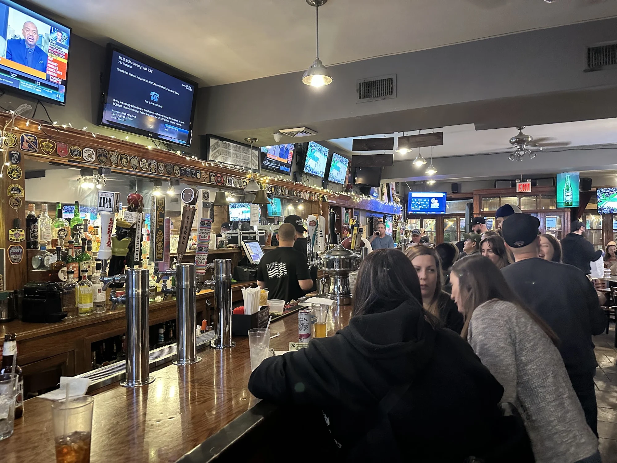 The Beer Garden featured image Interior of The Beer Garden, Castleton Corners, Bronx NYC with a lively bar scene and patrons seated around.