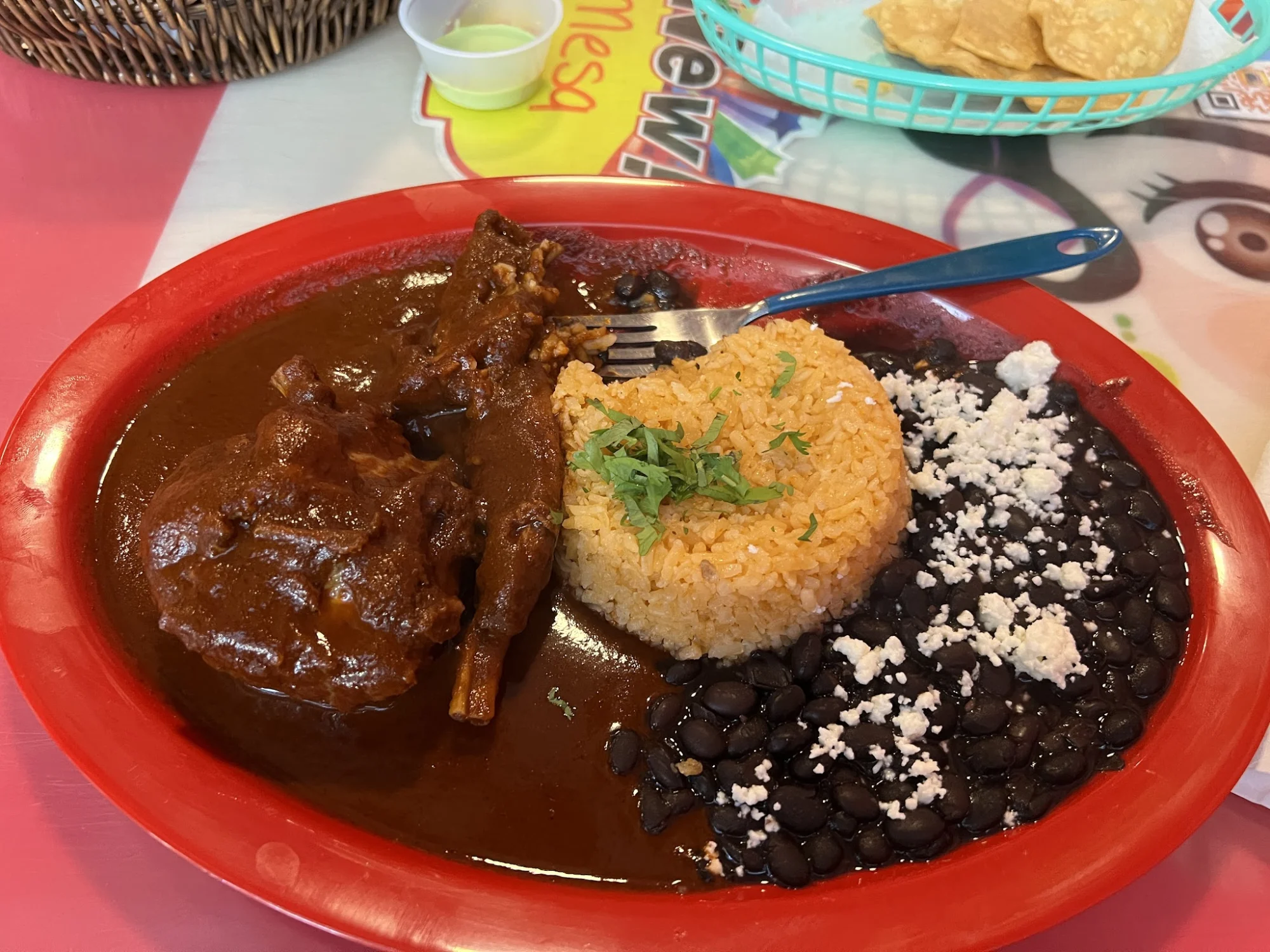 Plate with chicken mole, rice, and black beans at Xime Comida Mexicana, Mott Haven.