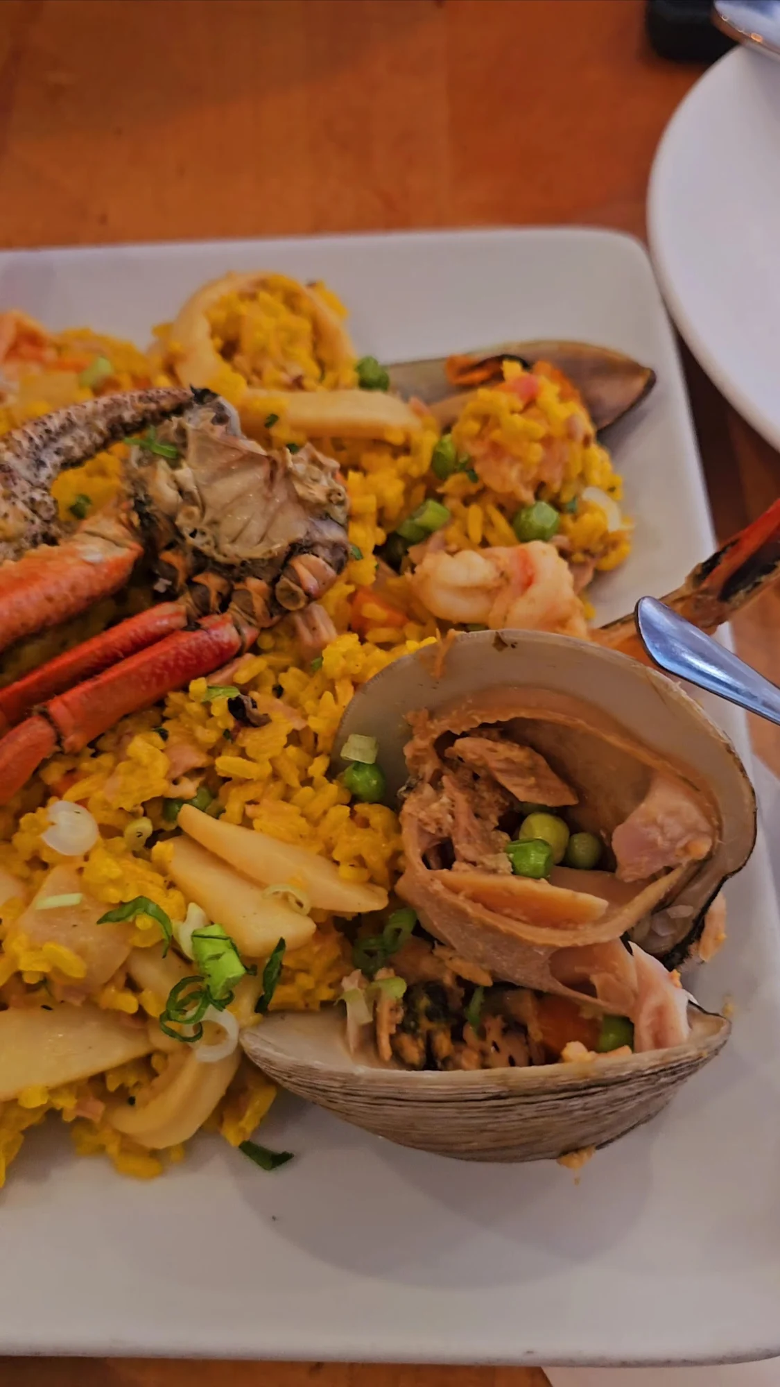 Close-up of seafood and rice dish with clams and crab at Rincón Melania, Long Island City.