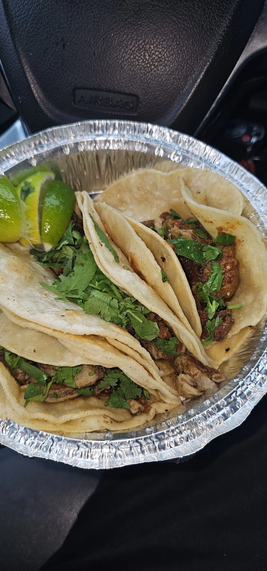 Tray of tacos with lime wedges and cilantro at Mercado Ariana, Arden Heights.