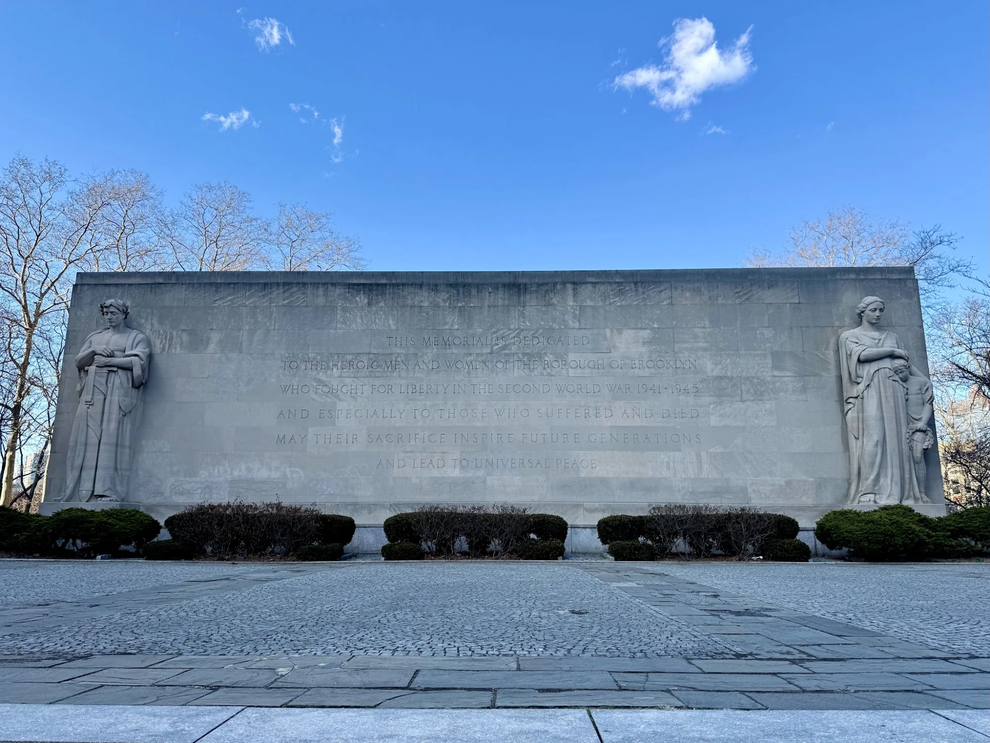 Brooklyn War Memorial featured image Large stone memorial with engraved text and two statues, Brooklyn War Memorial, Brooklyn Heights.