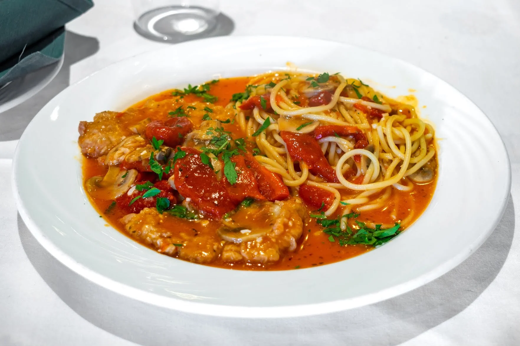 Casa Verde Restaurant featured image Plate of spaghetti with meat sauce, garnished with herbs, at Casa Verde Restaurant, Richmondtown.