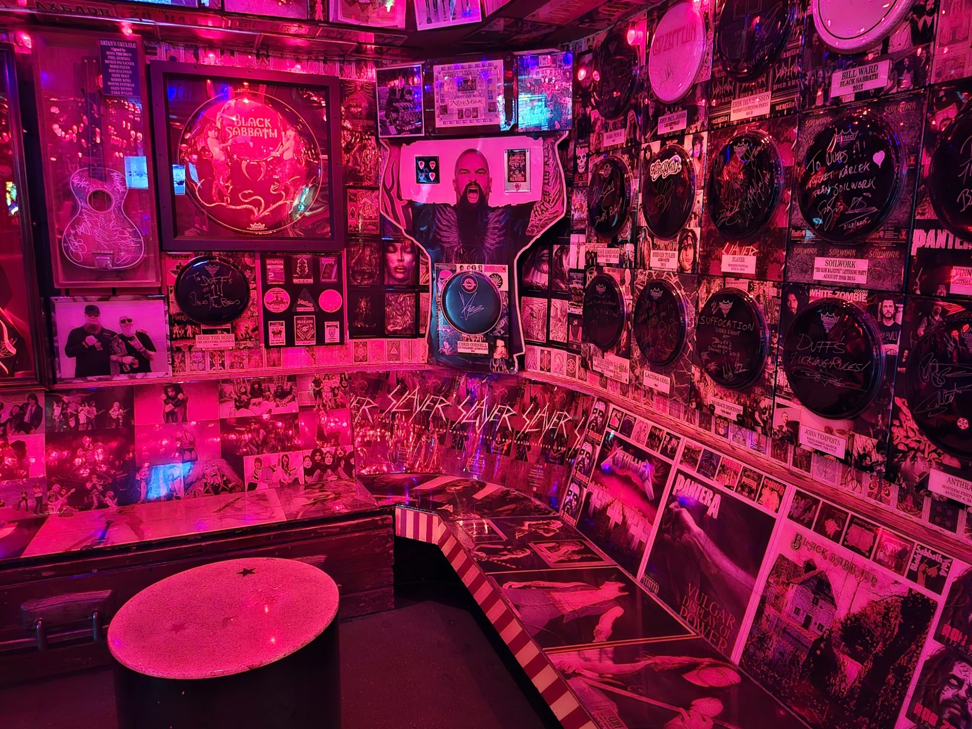 Interior of Duff's, Williamsburg with neon pink lighting, album covers, and posters on the walls.