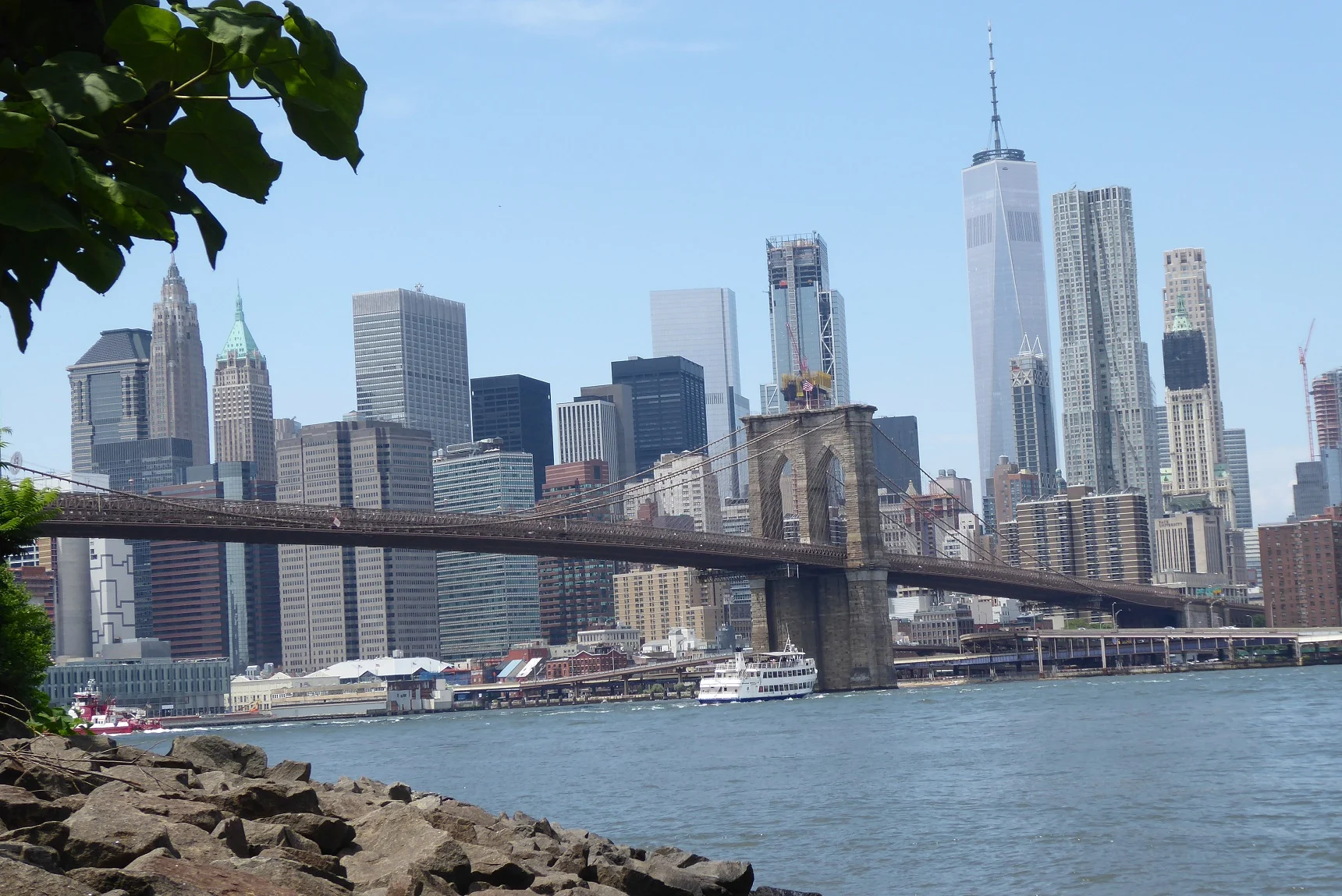 View of Brooklyn Bridge and Manhattan skyline from the waterfront in DUMBO, Brooklyn.