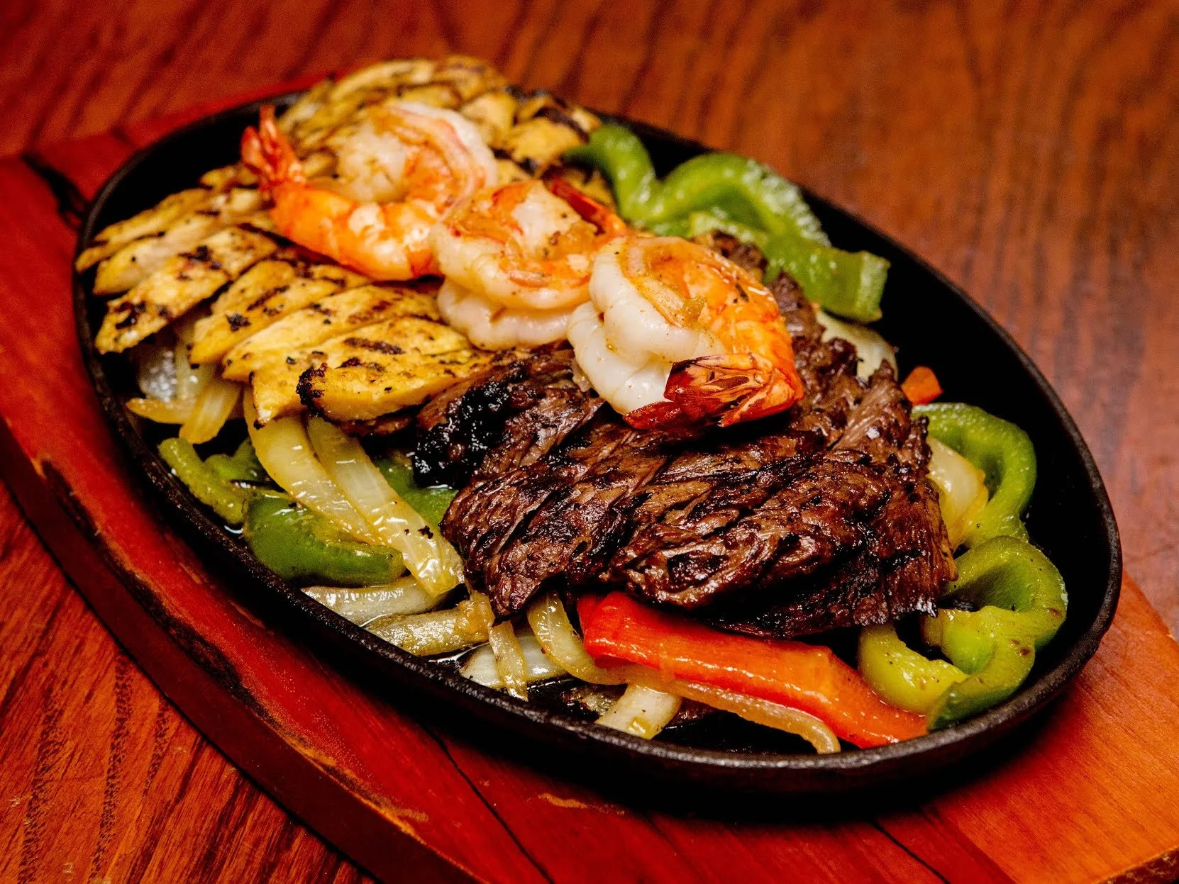 El Coyote featured image Sizzling platter with shrimp, beef, chicken, and vegetables at El Coyote, Jackson Heights.