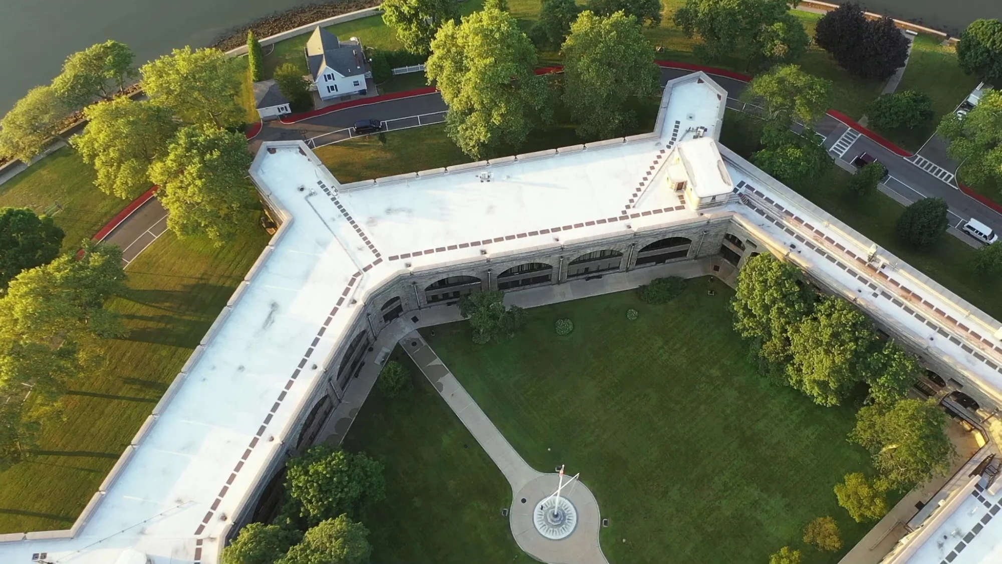 Maritime Industry Museum at Fort Schuyler featured image Aerial view of Fort Schuyler with a grassy courtyard and surrounding trees in Throgs Neck, Bronx NYC.