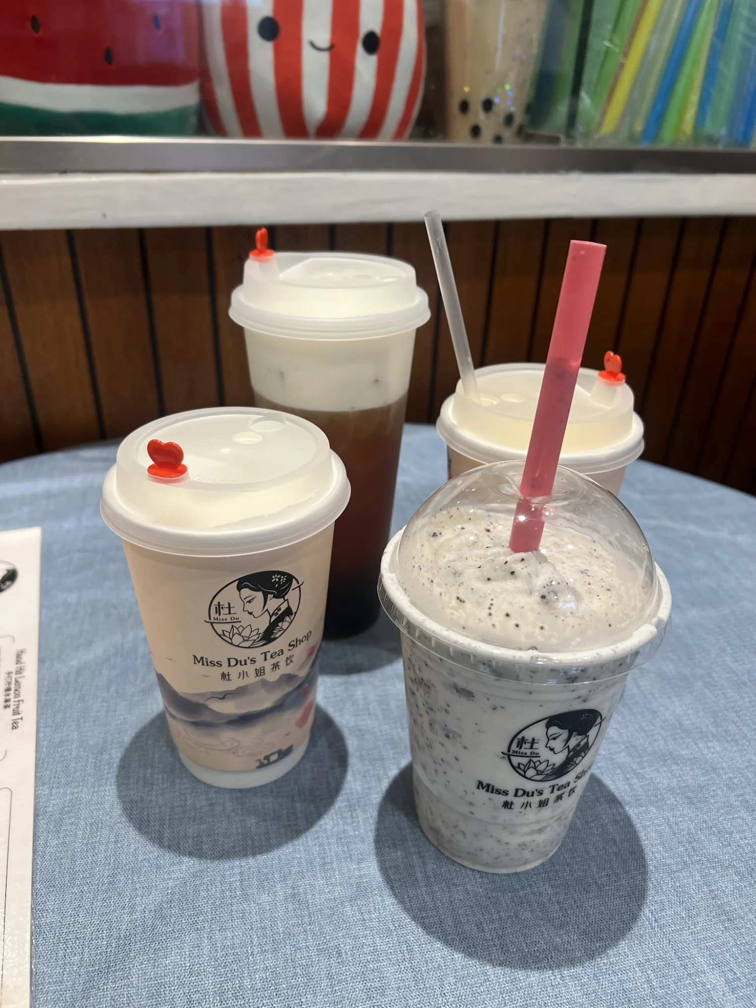 Miss Du's Tea Shop featured image Four bubble tea drinks on a table, each with different colors and toppings, at Miss Du's Tea Shop, Chinatown, Bronx NYC.
