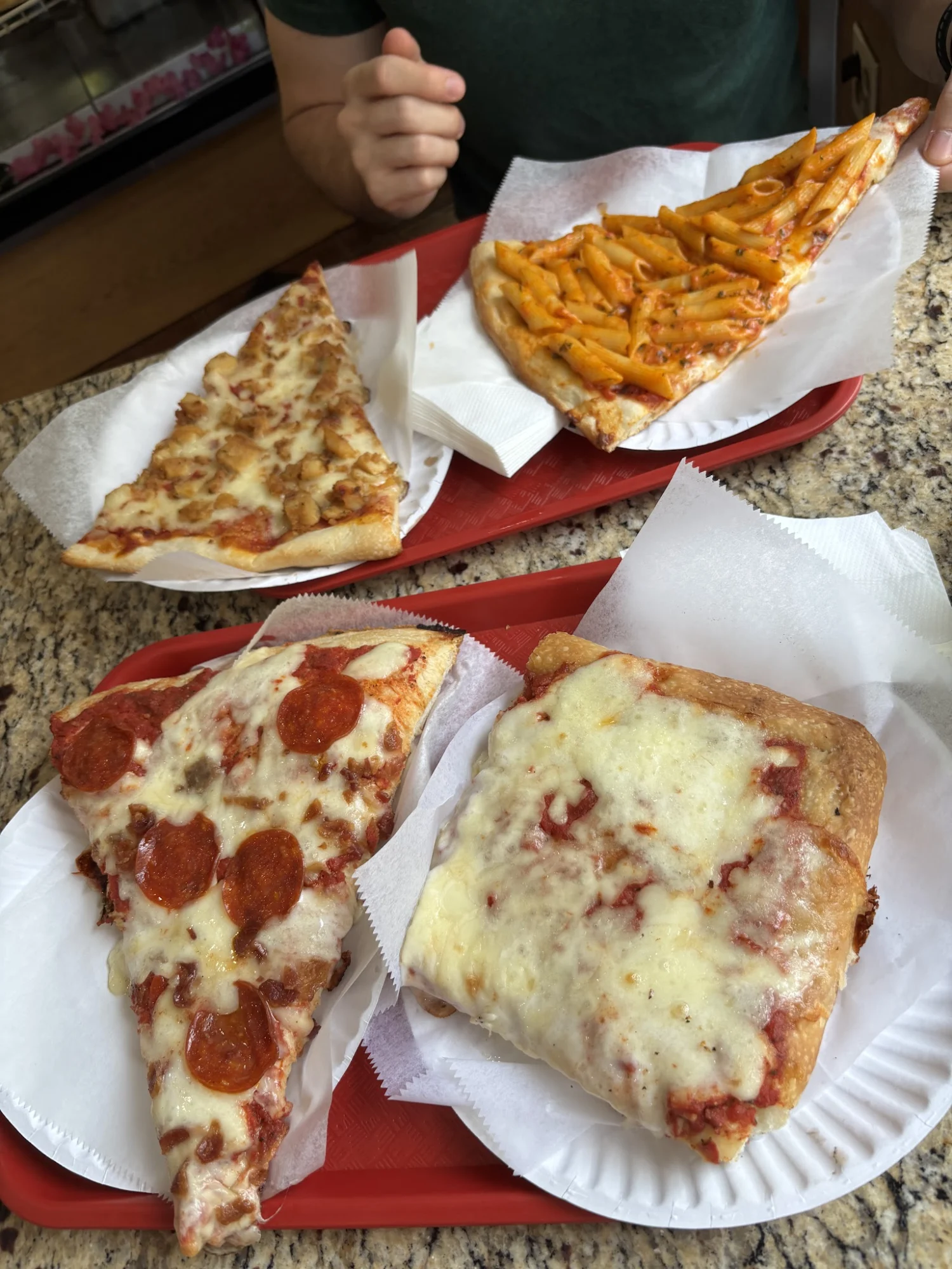 Gio's Pizza and Restaurant featured image Four pizza slices served on red trays at Gio's Pizza and Restaurant, Mott Haven.