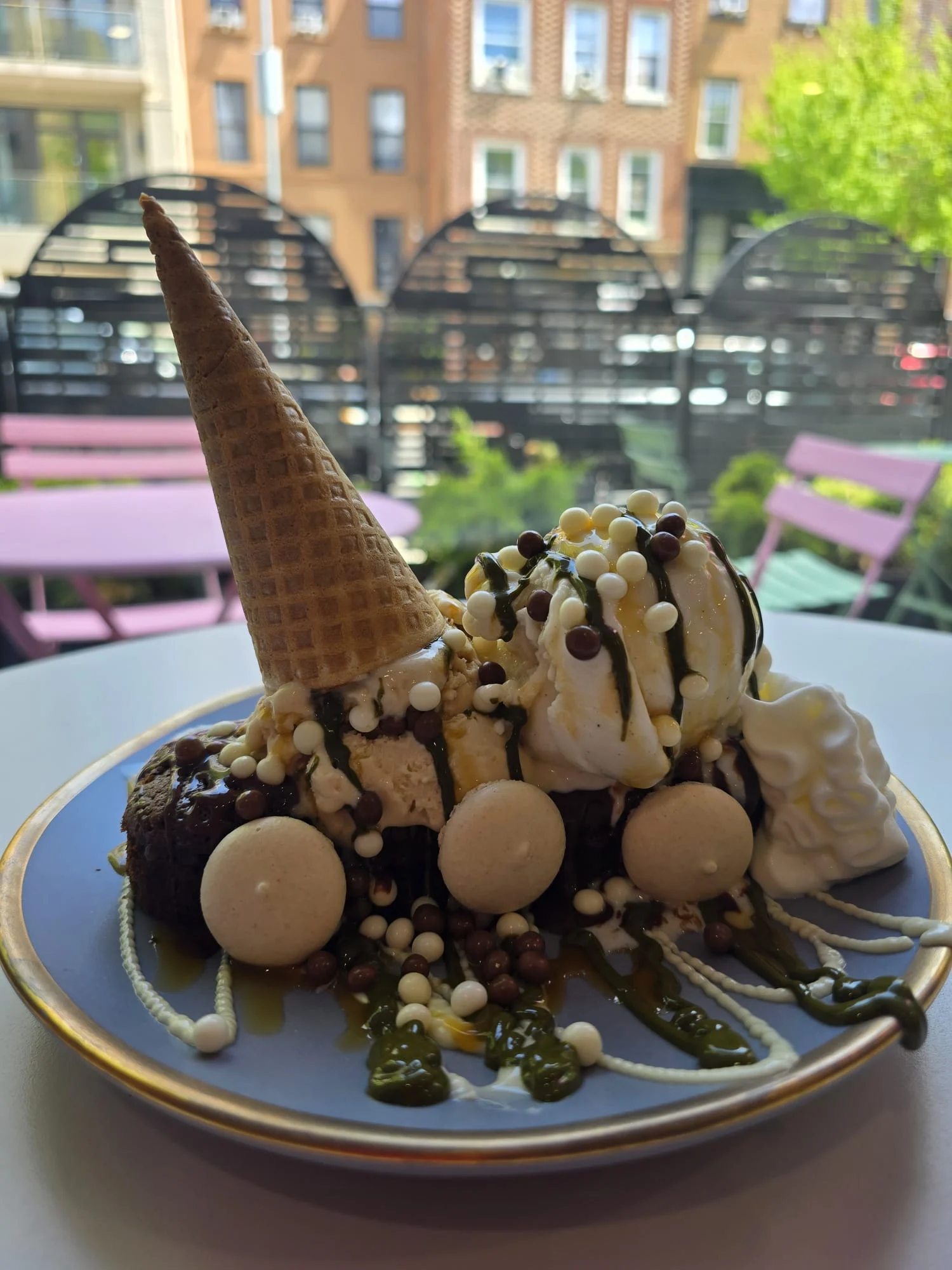 Della Nonna Gelato featured image Ice cream dessert with cone and toppings on a plate at Della Nonna Gelato, Bronx NYC.