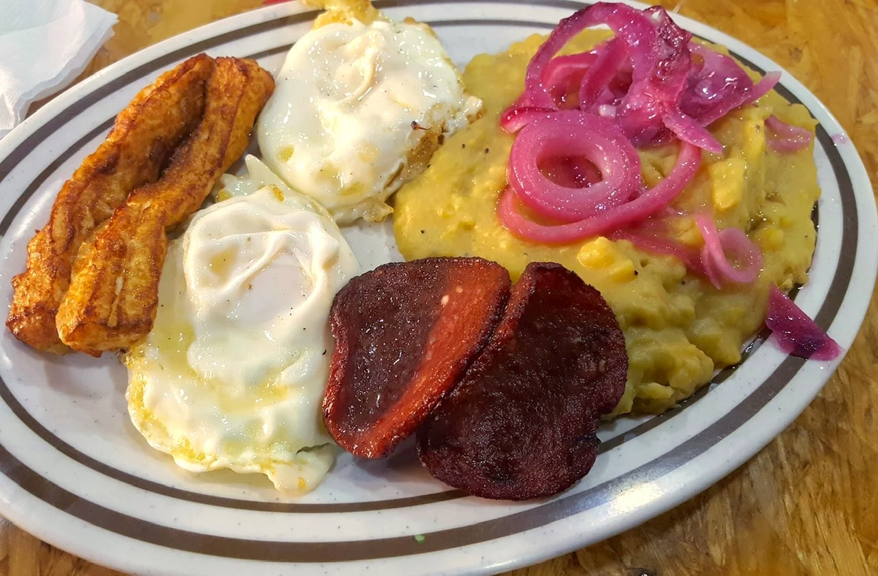 Plate with fried eggs, plantains, beetroot slices, mashed potatoes, and pickled onions at La Cabaña Rodríguez, Flatbush.