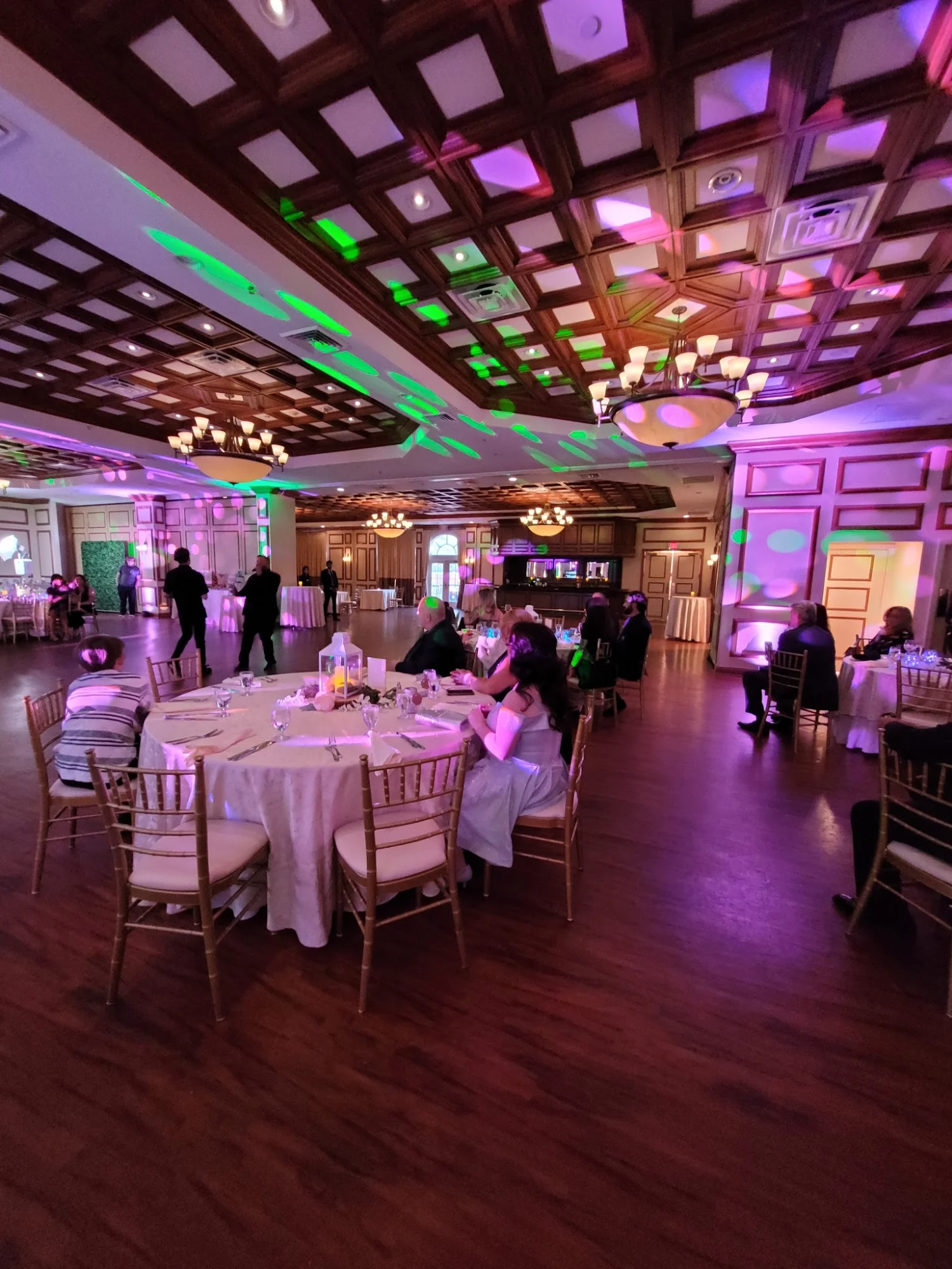 Elegant interior of Island Entertainment, Dongan Hills, with diners and colorful lighting.