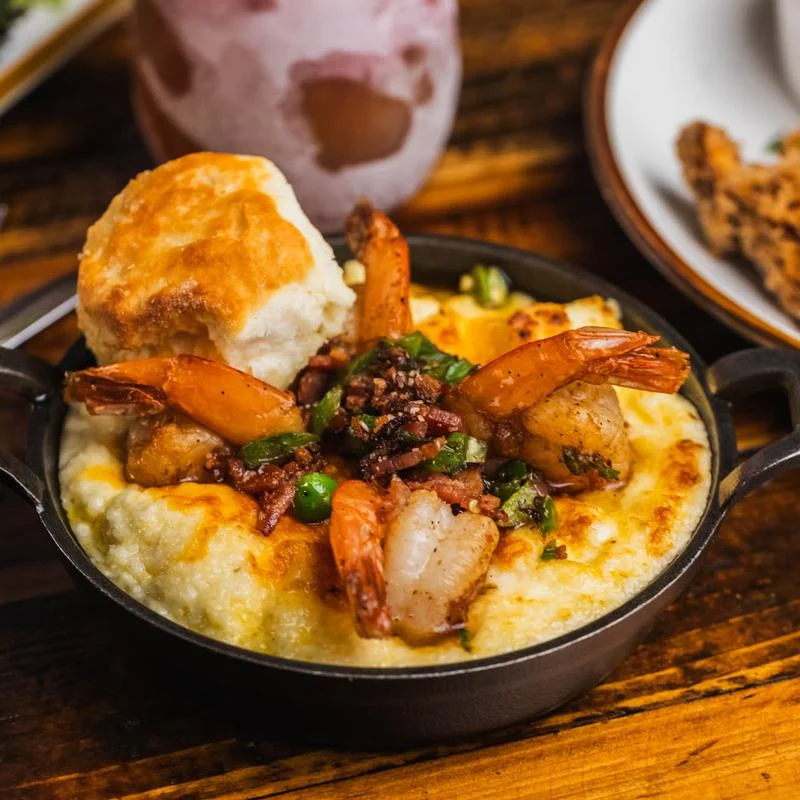 Bowl with shrimp, grits, and biscuit at BLVD Bistro in Harlem.