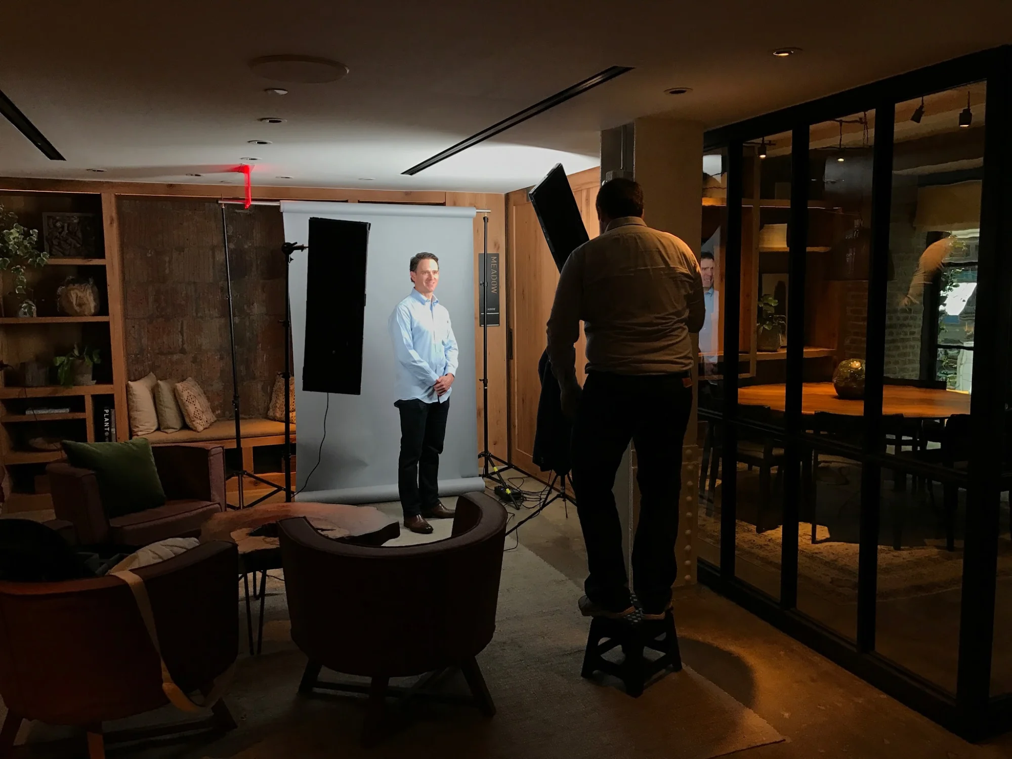 NY Headshots featured image Photography setup in office with photographer adjusting lights, NY Headshots, Theater District, Bronx NYC.
