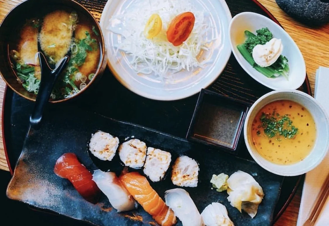DOMODOMO New York featured image Assorted sushi platter with miso soup and garnishes on a wooden table at DOMODOMO New York, Greenwich Village.