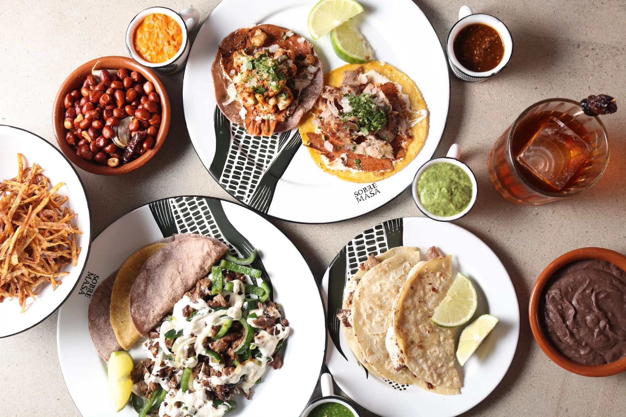 Sobre Masa featured image Plates of assorted dishes, including tacos and sides, at Sobre Masa, Bushwick.