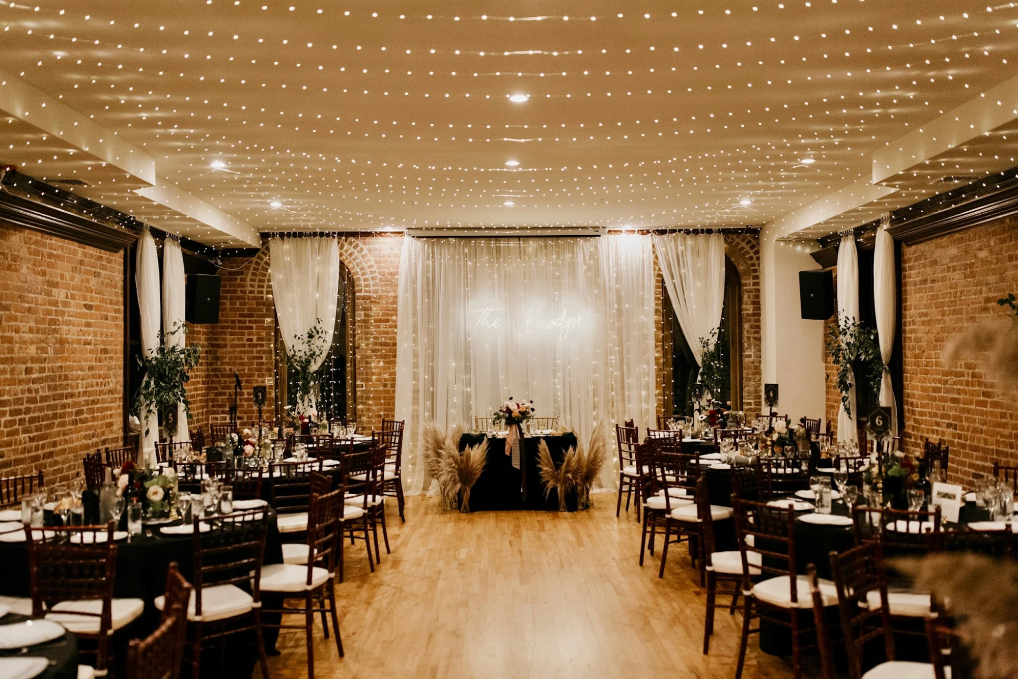 Deity Weddings and Events featured image Deity Weddings and Events interior with string lights and wooden floors, Boerum Hill.