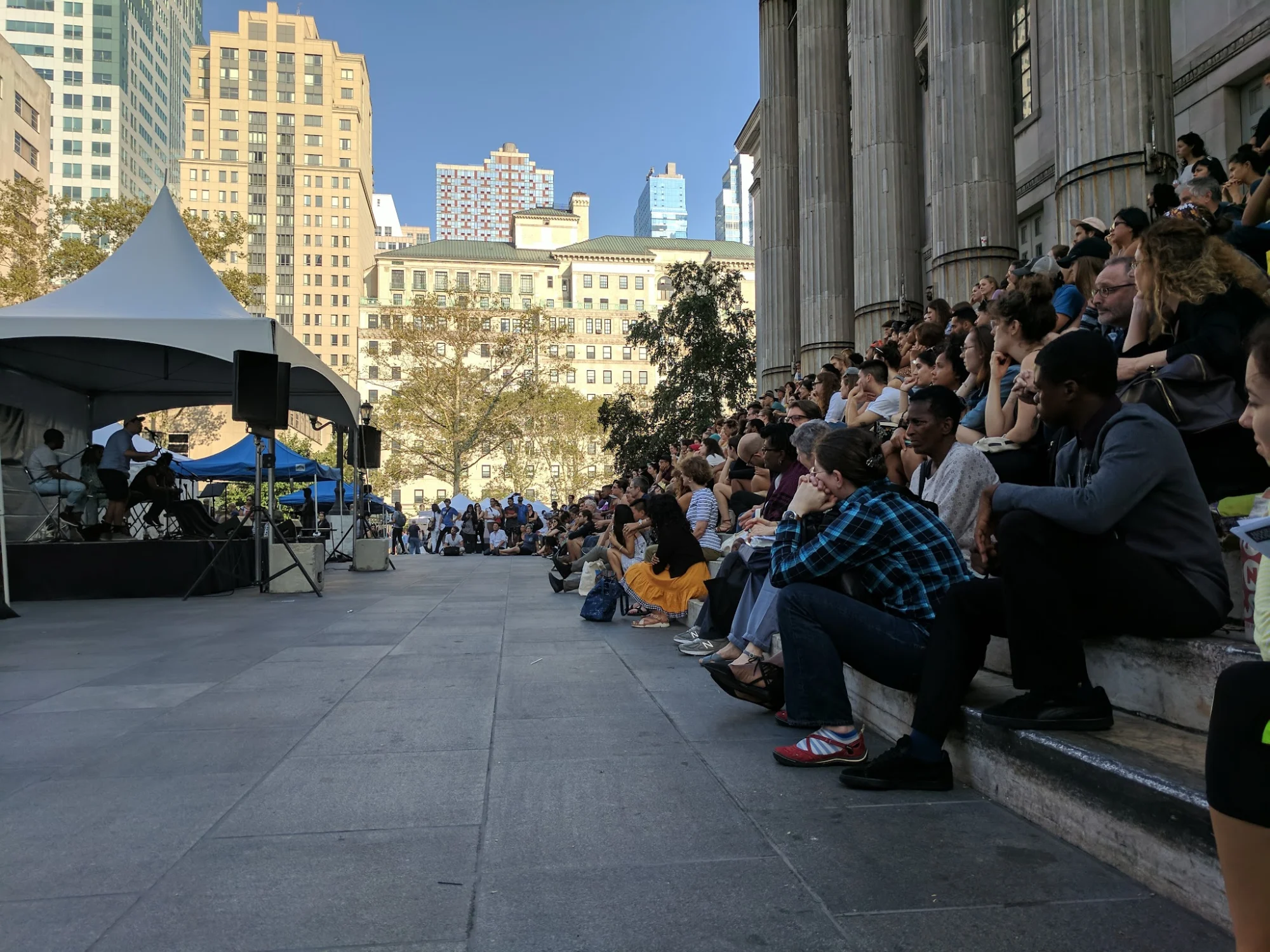 Outdoor crowd seated on steps watching a presentation at Brooklyn Book Festival, Downtown Brooklyn.