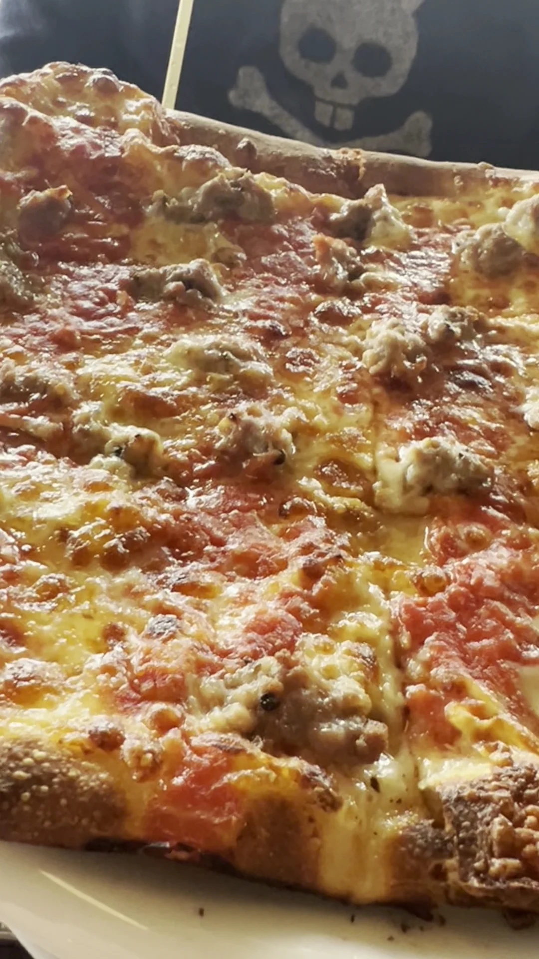 Close-up of a pizza topped with cheese and sausage pieces at Seppe Pizza Bar, Stapleton.