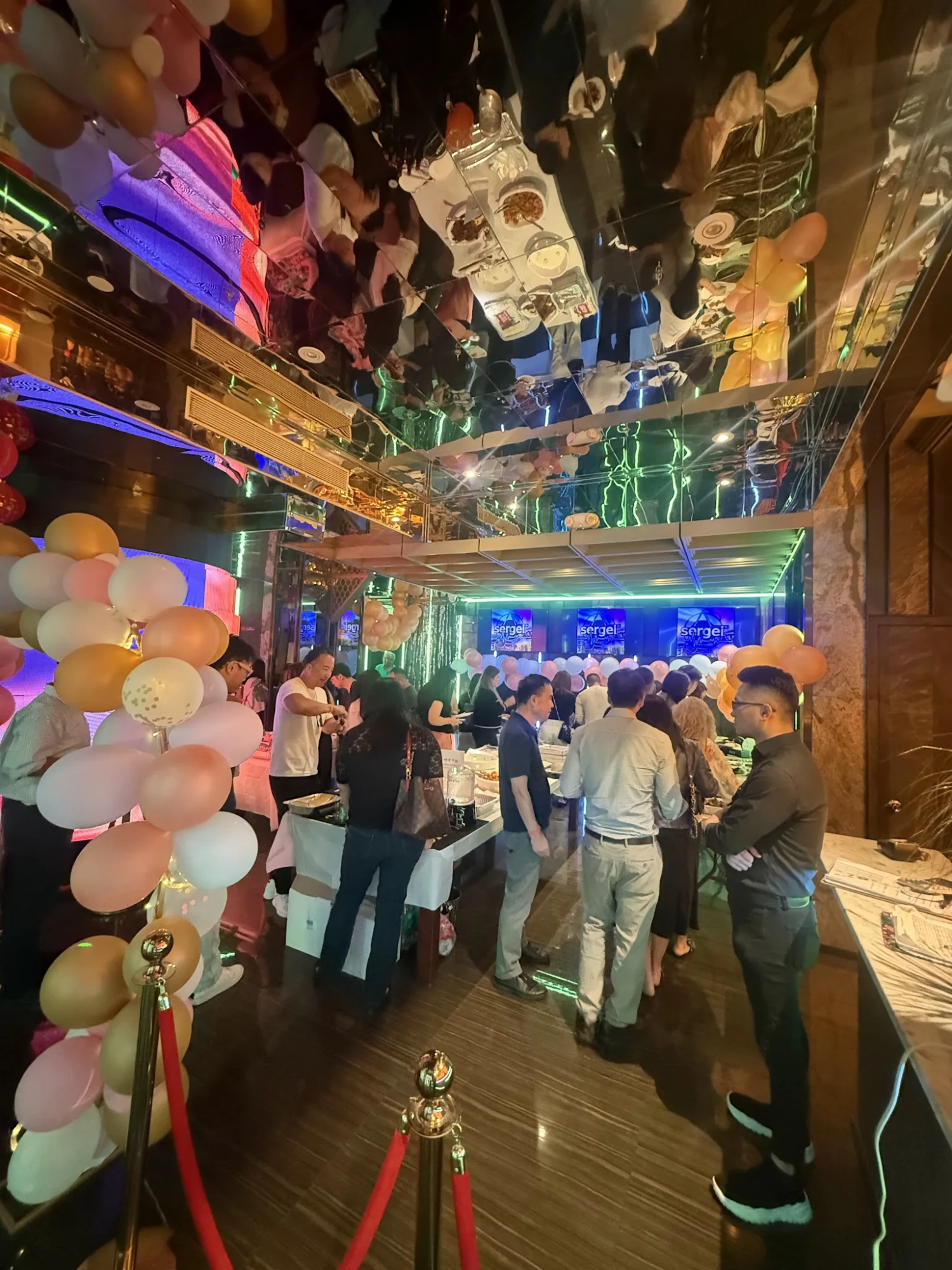 DY SHOW KTV featured image Interior of DY SHOW KTV in College Point, Bronx NYC with partygoers, balloons, and vibrant lighting.