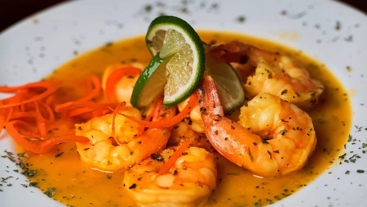 Shrimp dish with lime wedges and sauce, Fiesta Lounge and Restaurant, Belmont Bronx NYC.