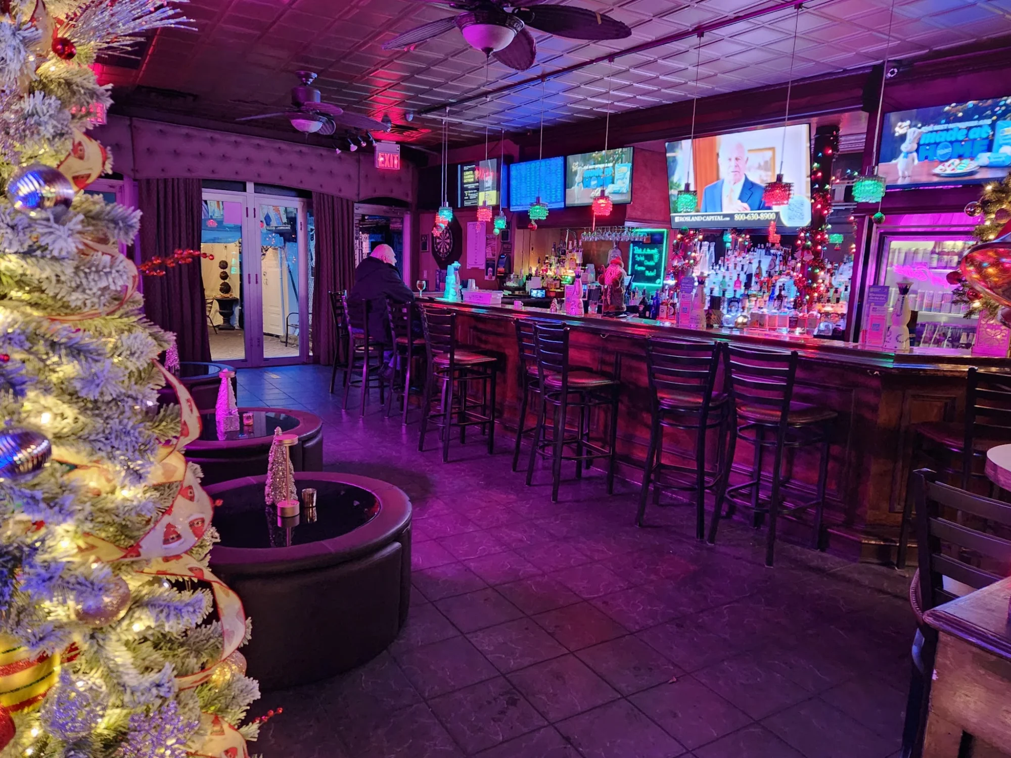 Unique Lounge & Billiards featured image Bar interior with festive decor, multiple screens, and a row of stools in Unique Lounge & Billiards, Arden Heights.
