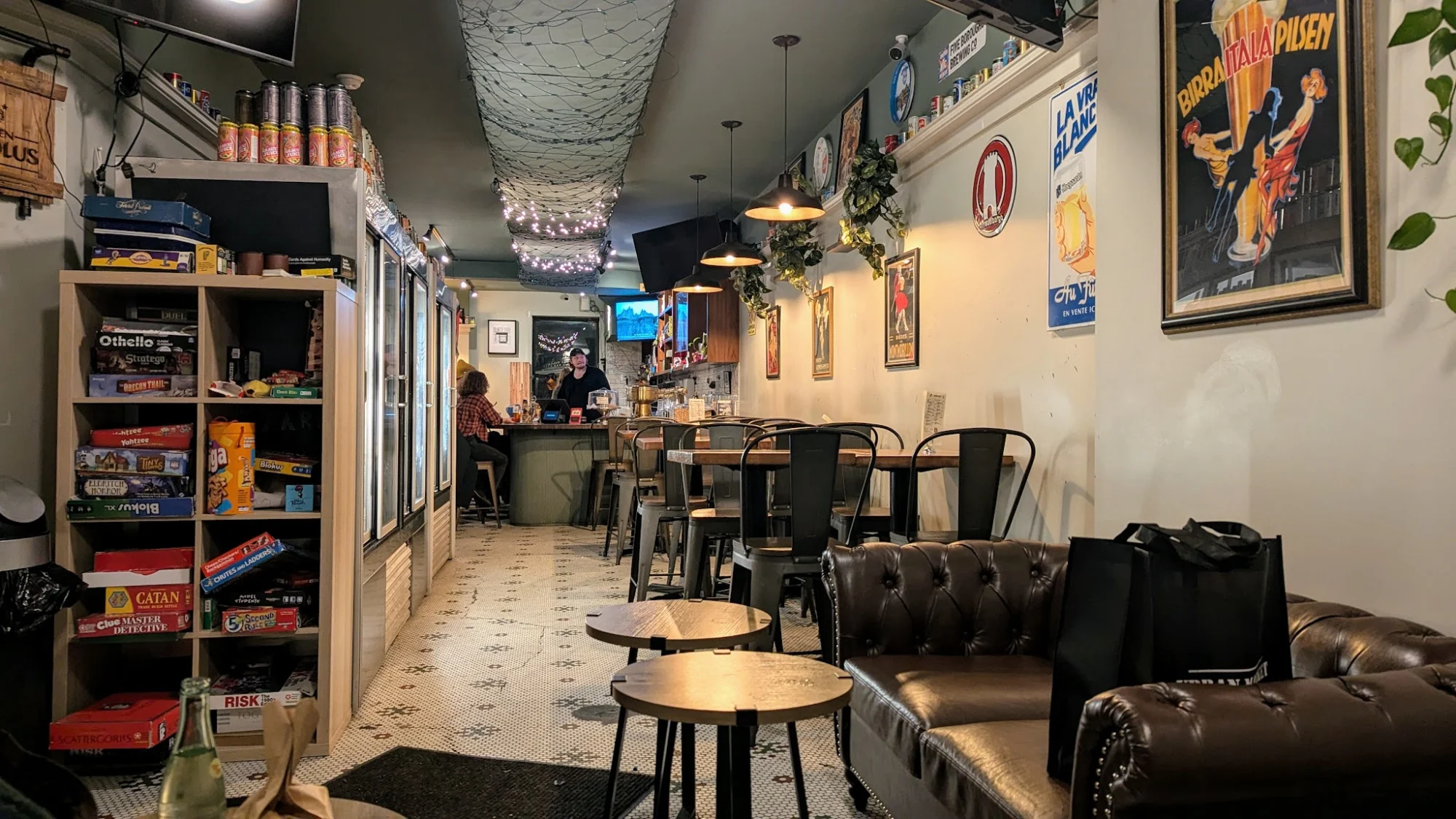 Interior of Brewer's Row, Park Slope, with cozy seating, board games, and wall art.